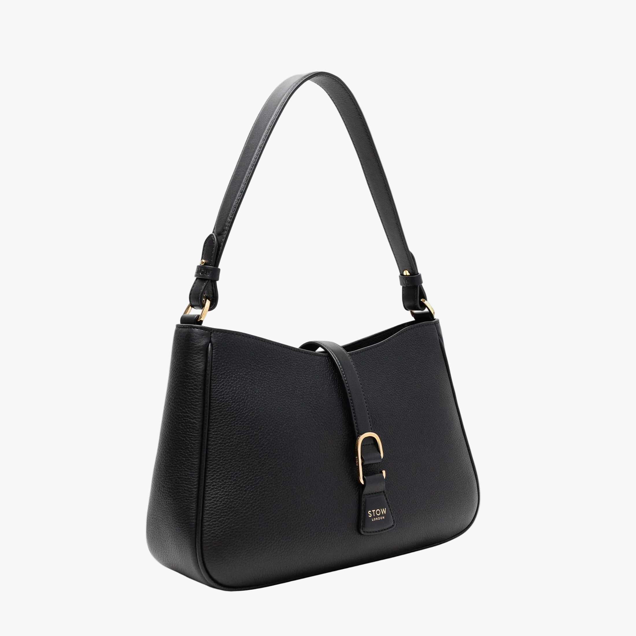 Off-axis view of STOW London's Beth bag in Black pebbled and smooth leather featuring gold-coated stainless steel hardware and clip on a white background
