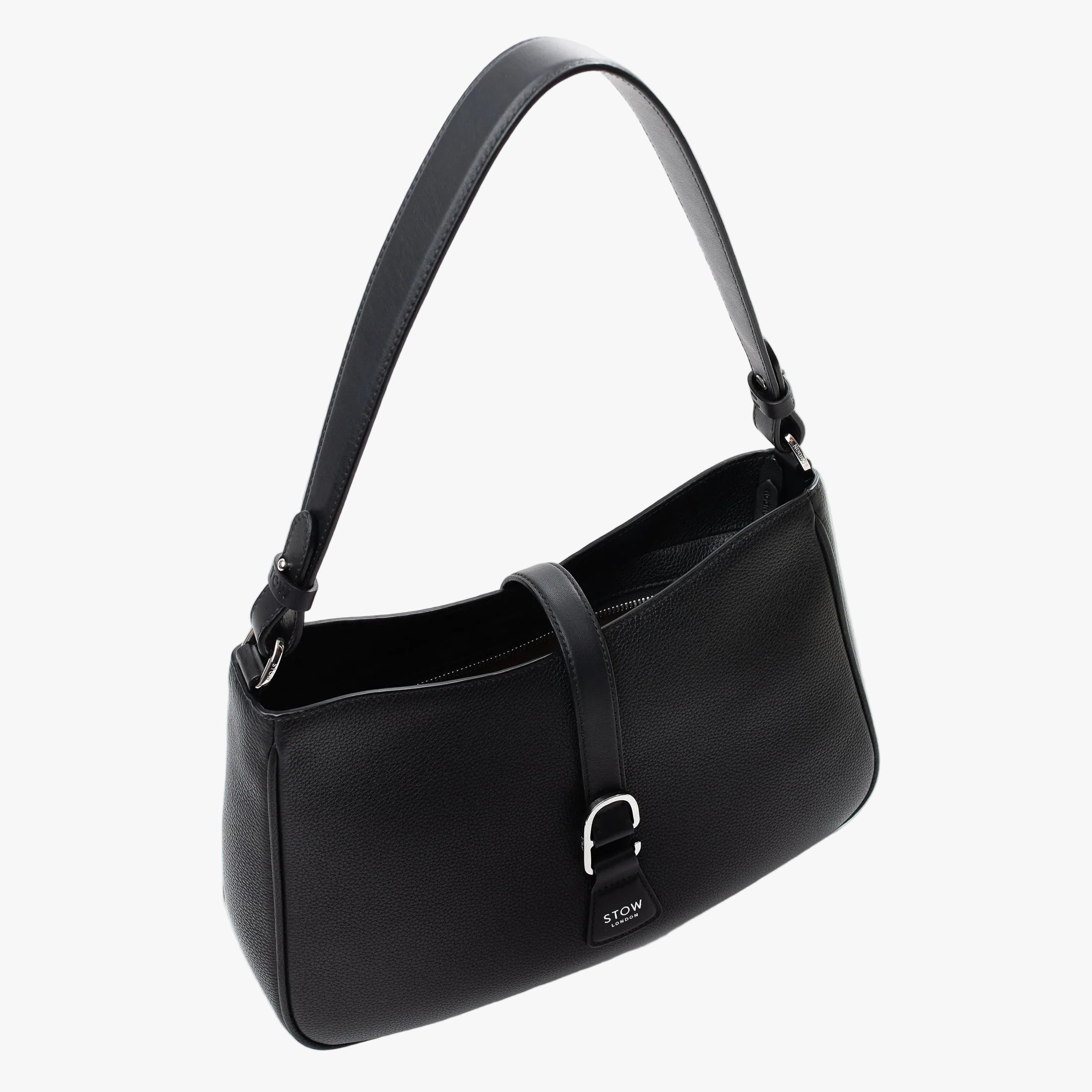 Top angled view of STOW London's Beth bag in Black pebbled and smooth leather with zipper open showing the interior cotton lining and card holder pocket, featuring silver stainless steel hardware on a white background