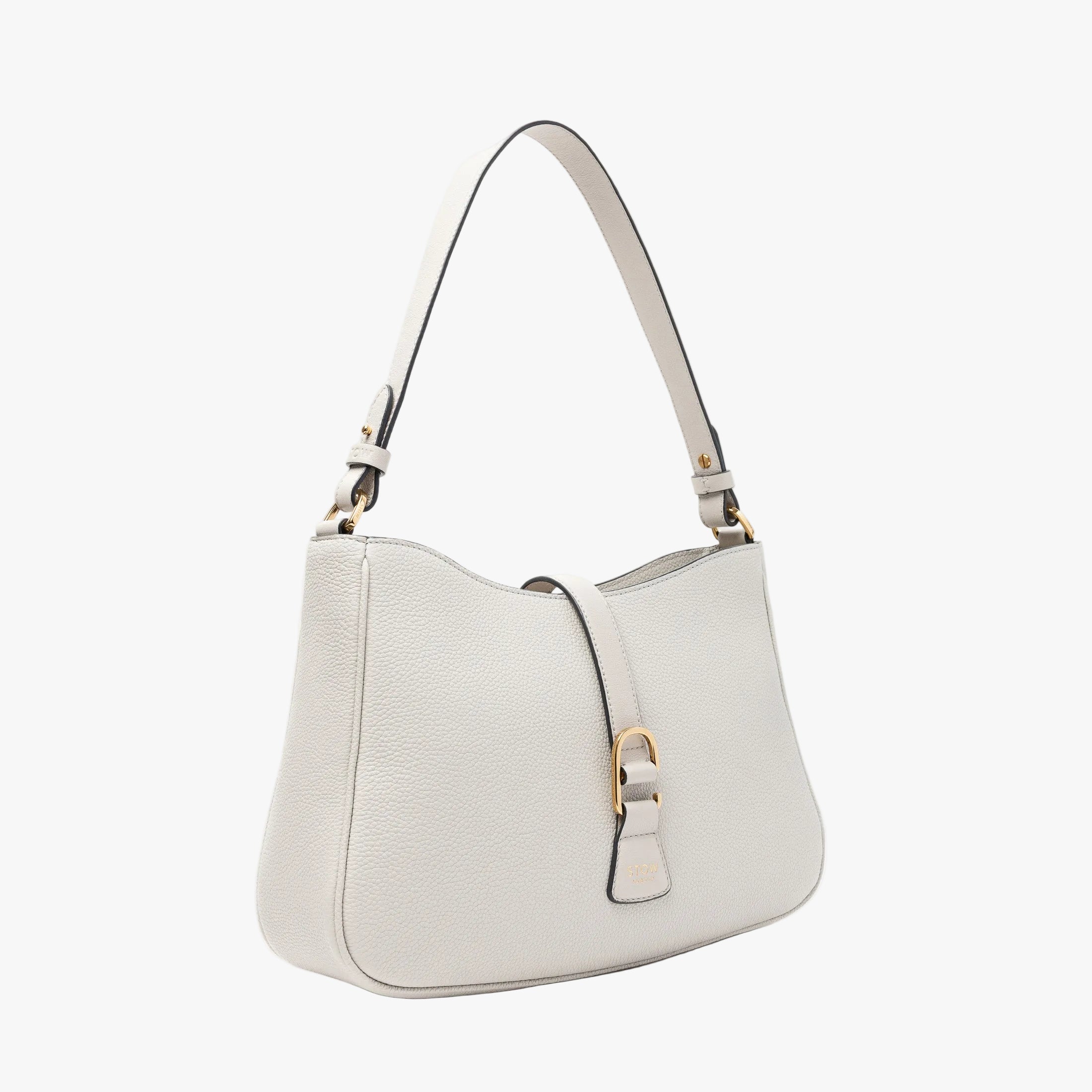 Off-axis view of STOW London's Beth bag in Cloud Grey pebbled and smooth leather featuring gold-coated stainless steel hardware and clip on a white background
