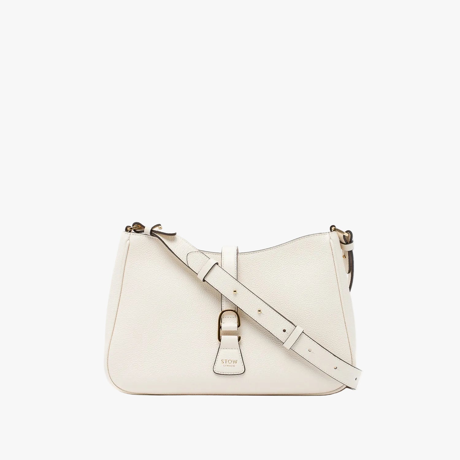 STOW London's Beth bag and detachable crossbody strap in Spring Moon leather featuring gold stainless steel hardware on a white background