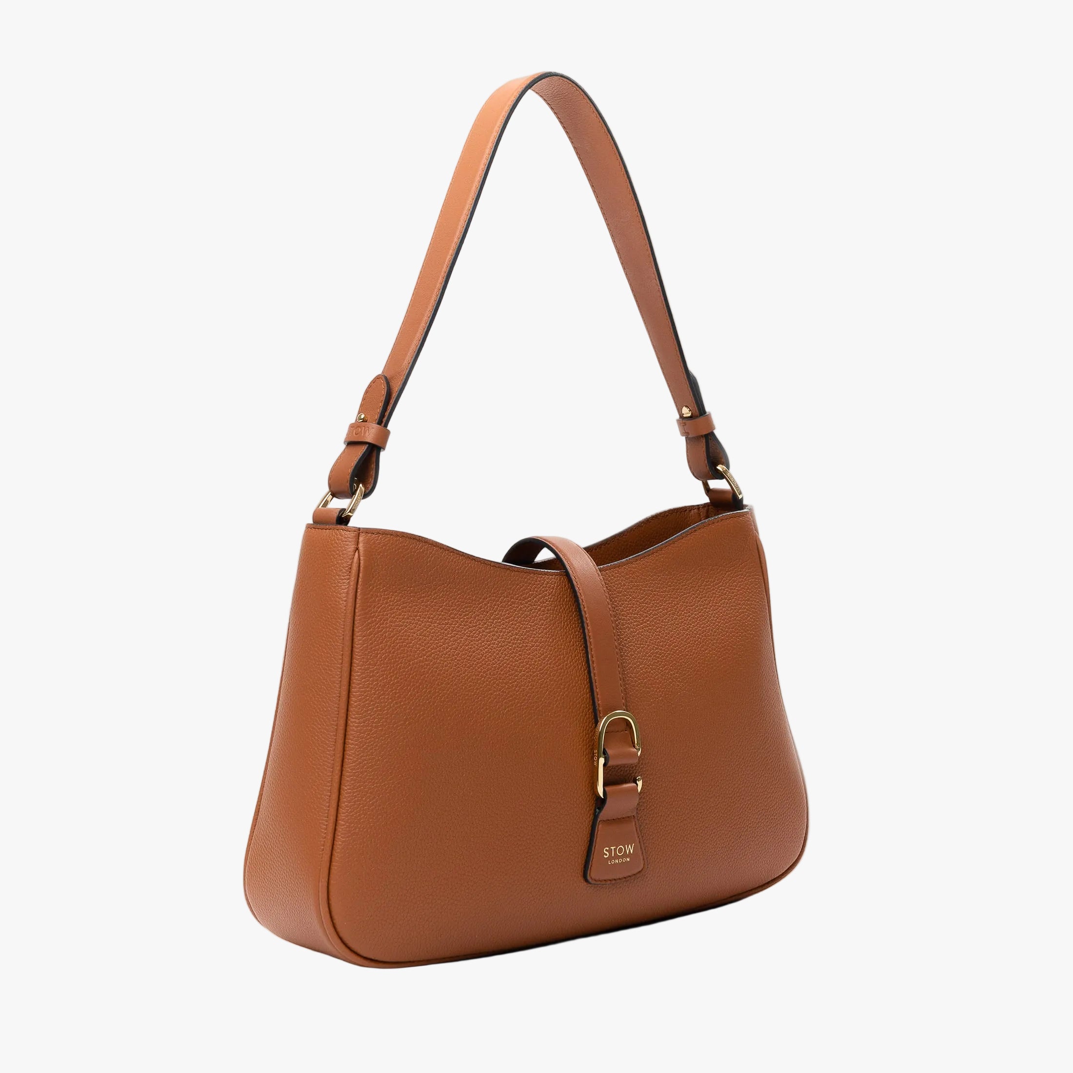 Off-axis view of STOW London's Beth bag in Earth Tan pebbled and smooth leather featuring gold-coated stainless steel hardware and clip on a white background