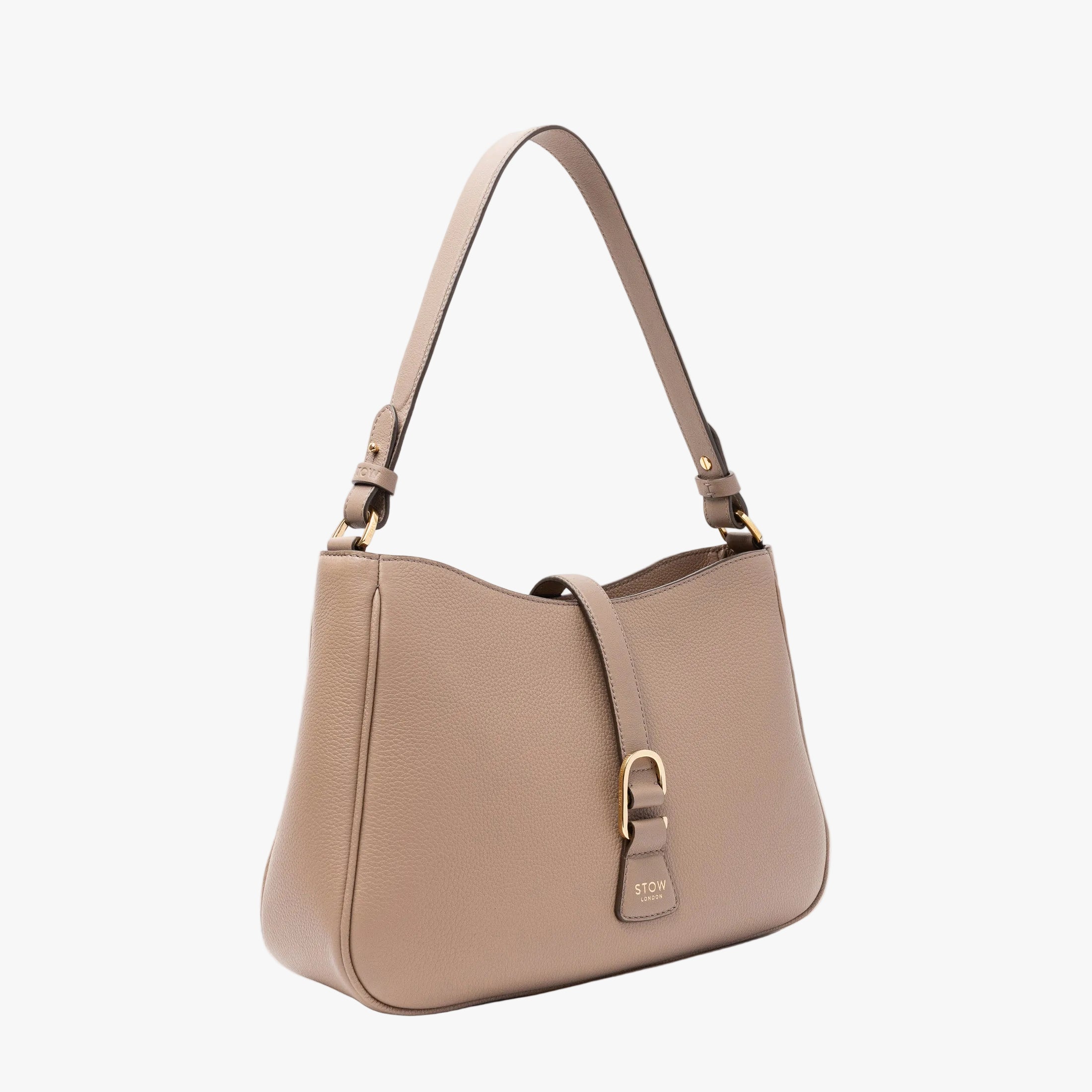 Off-axis view of STOW London's Beth bag in Warm Taupe pebbled and smooth leather featuring gold-coated stainless steel hardware and clip on a white background