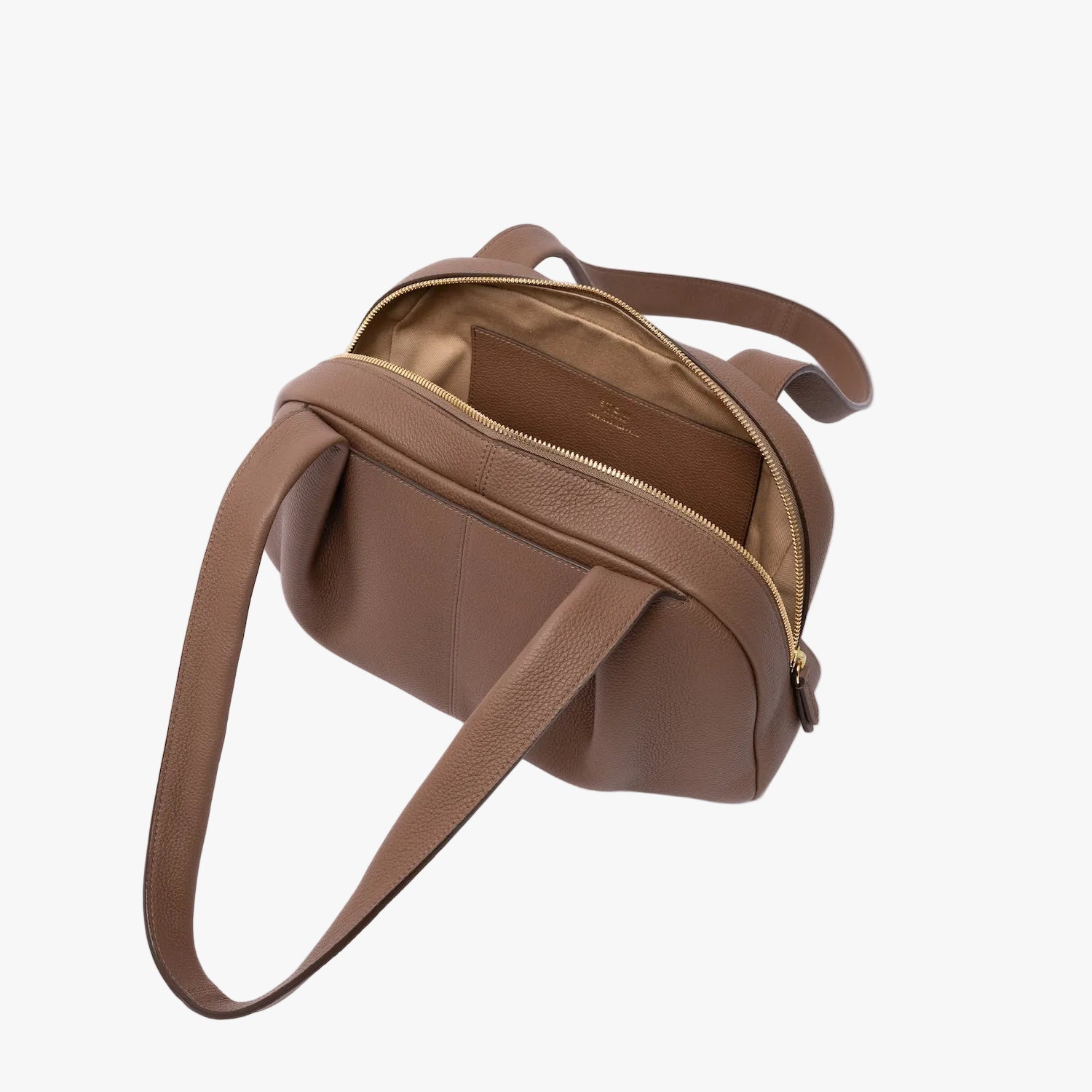 Top view of STOW London's Bowling bag in Mocha pebbled leather on a light grey background with zip open showing interior cotton lining and leather slip pocket