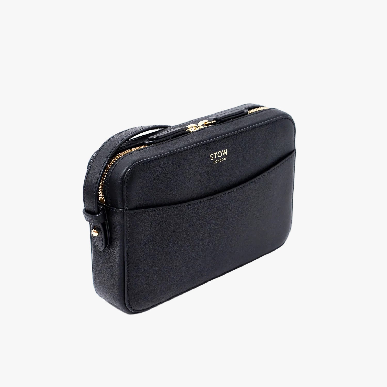 Off-axis view of STOW London's Camera bag in Navy Smooth leather featuring gold-coated stainless steel hardware on a white background