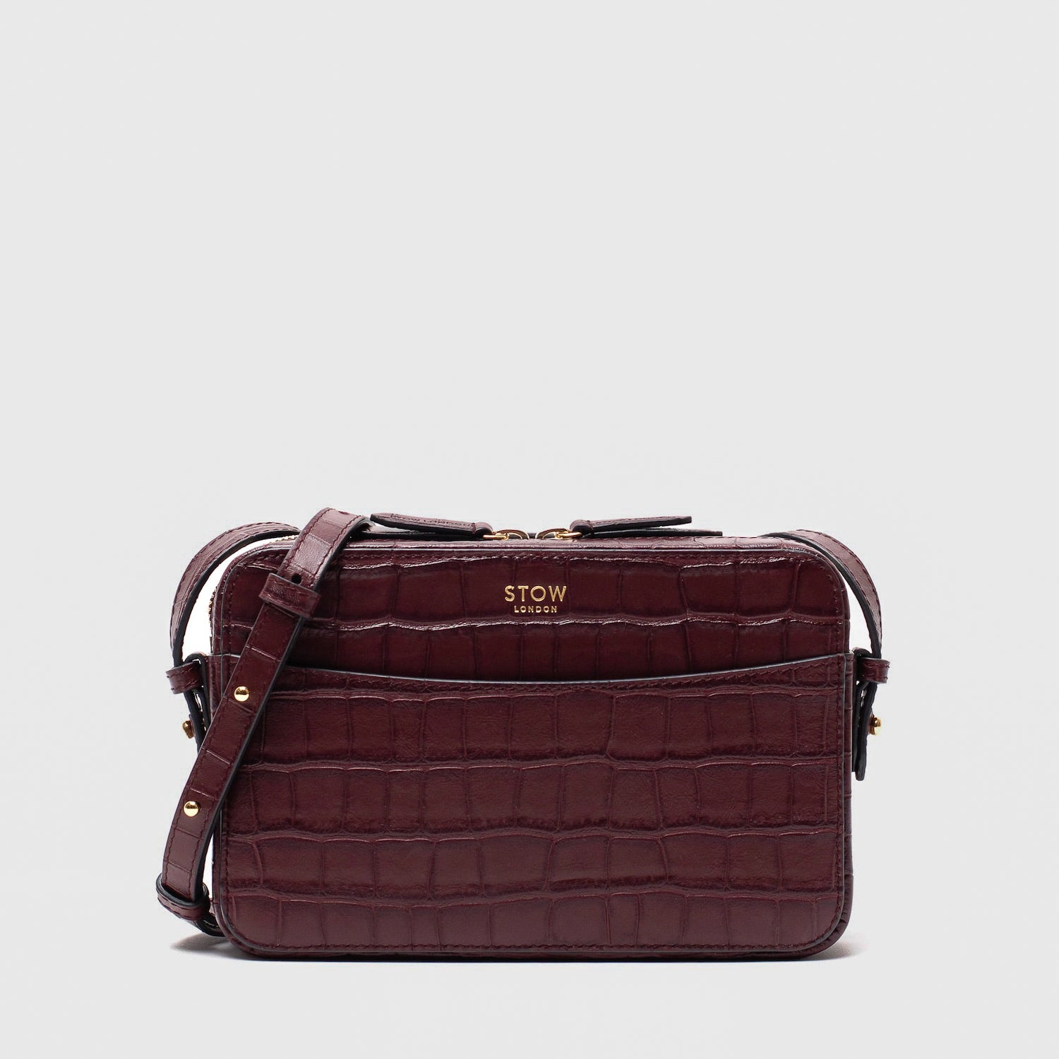 STOW London's Camera bag in Burgundy Embossed Croc leather with detachable crossbody strap featuring gold-coated stainless steel hardware on a white background