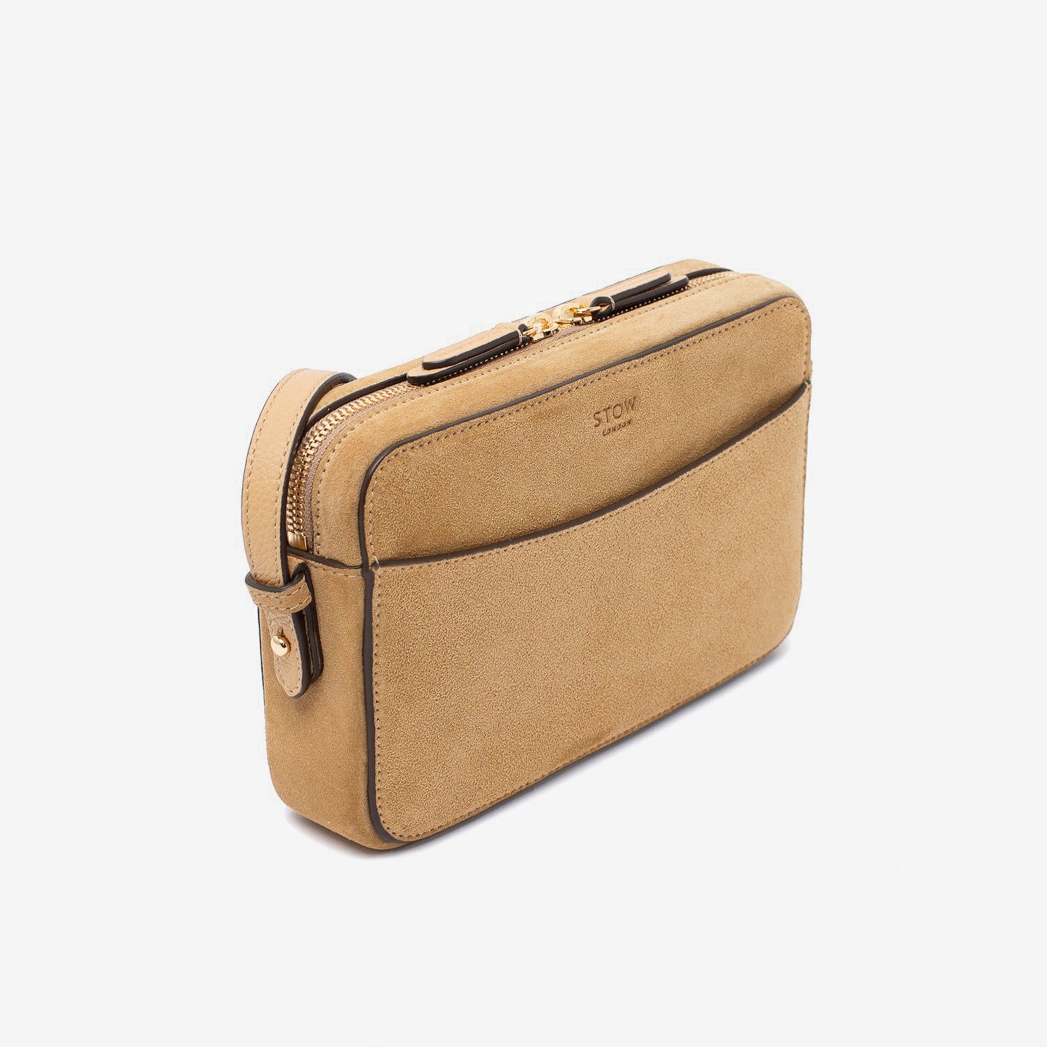 Off-axis view of STOW London's Camera bag in Soft Sand Suede leather featuring gold-coated stainless steel hardware on a white background