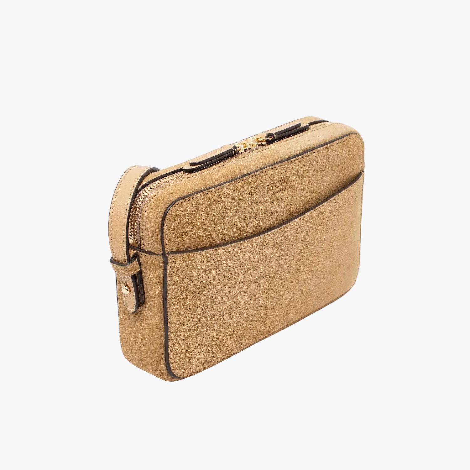 Off-axis view of STOW London's Camera bag in Soft Sand Suede leather featuring gold-coated stainless steel hardware on a white background