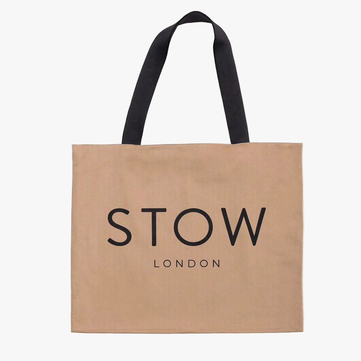 Beige tote bag with 'STOW LONDON' text with black handles on a light grey background