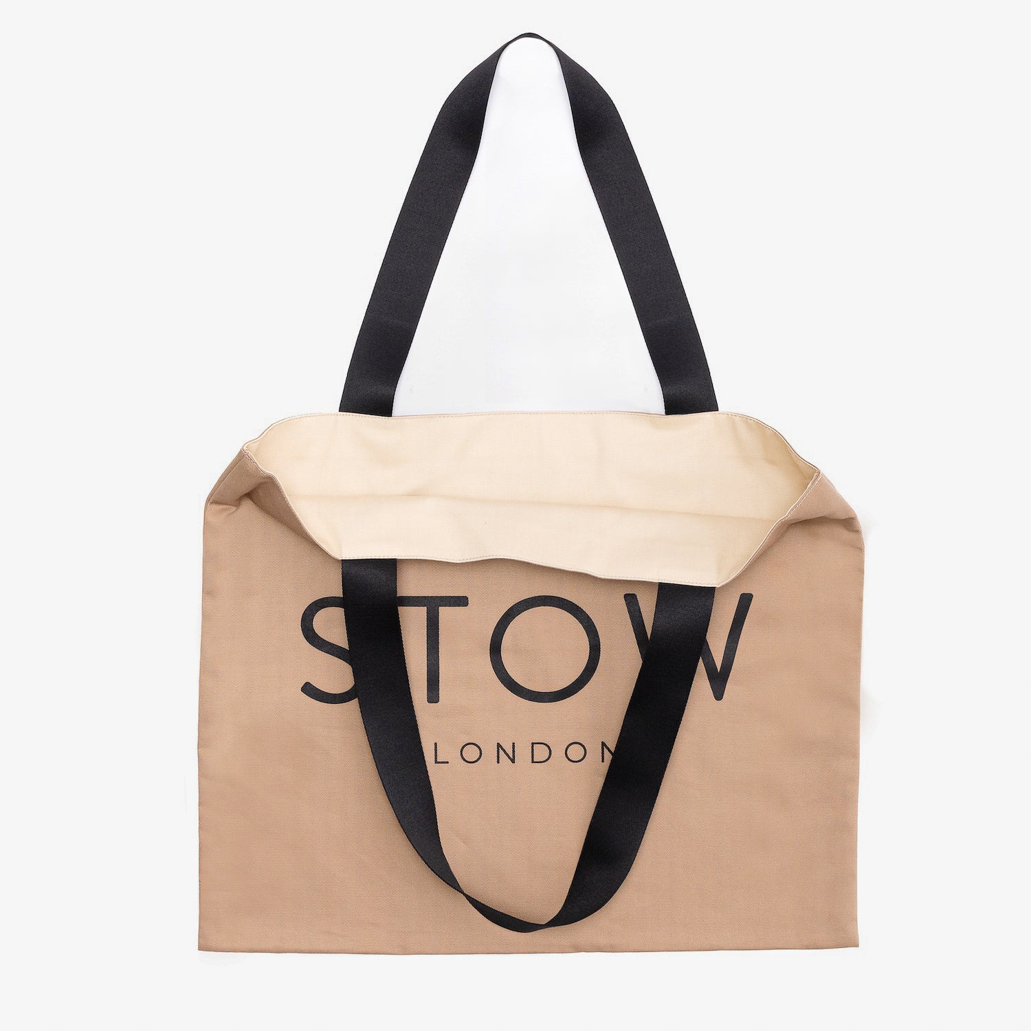 Beige tote bag with black handles and 'STOW LONDON' branding on a white background