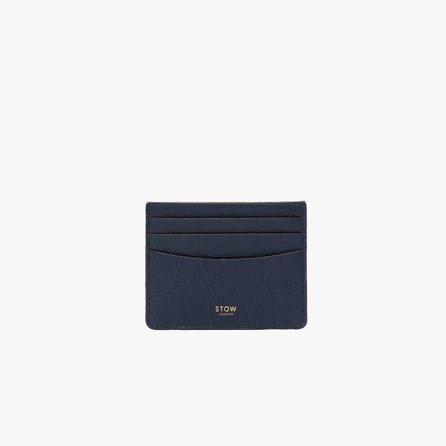 STOW London's Cardholder in Navy pebbled leather on a light grey background featuring a fine gold embossed logo on the front bottom.