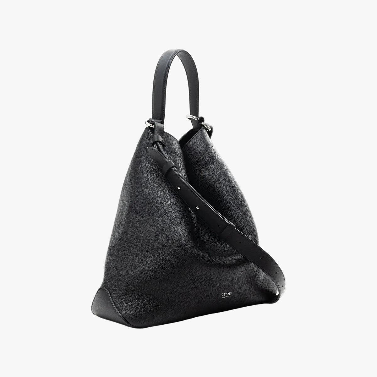 Off-axis view of STOW London's Curve bag in Black pebbled leather featuring silver stainless steel hardware on a light grey background