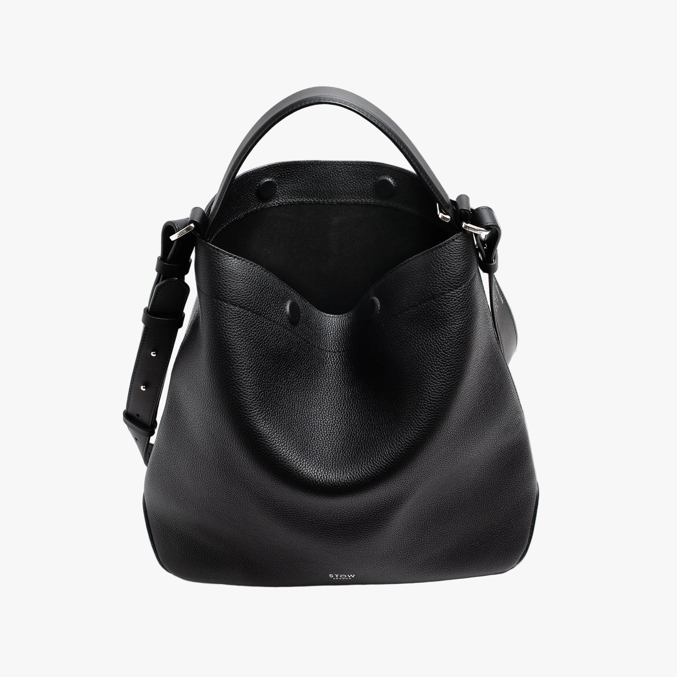STOW London's Curve bag in Black pebbled leather with magnets open the black suede interior lining featuring silver stainless steel hardware on a light grey background