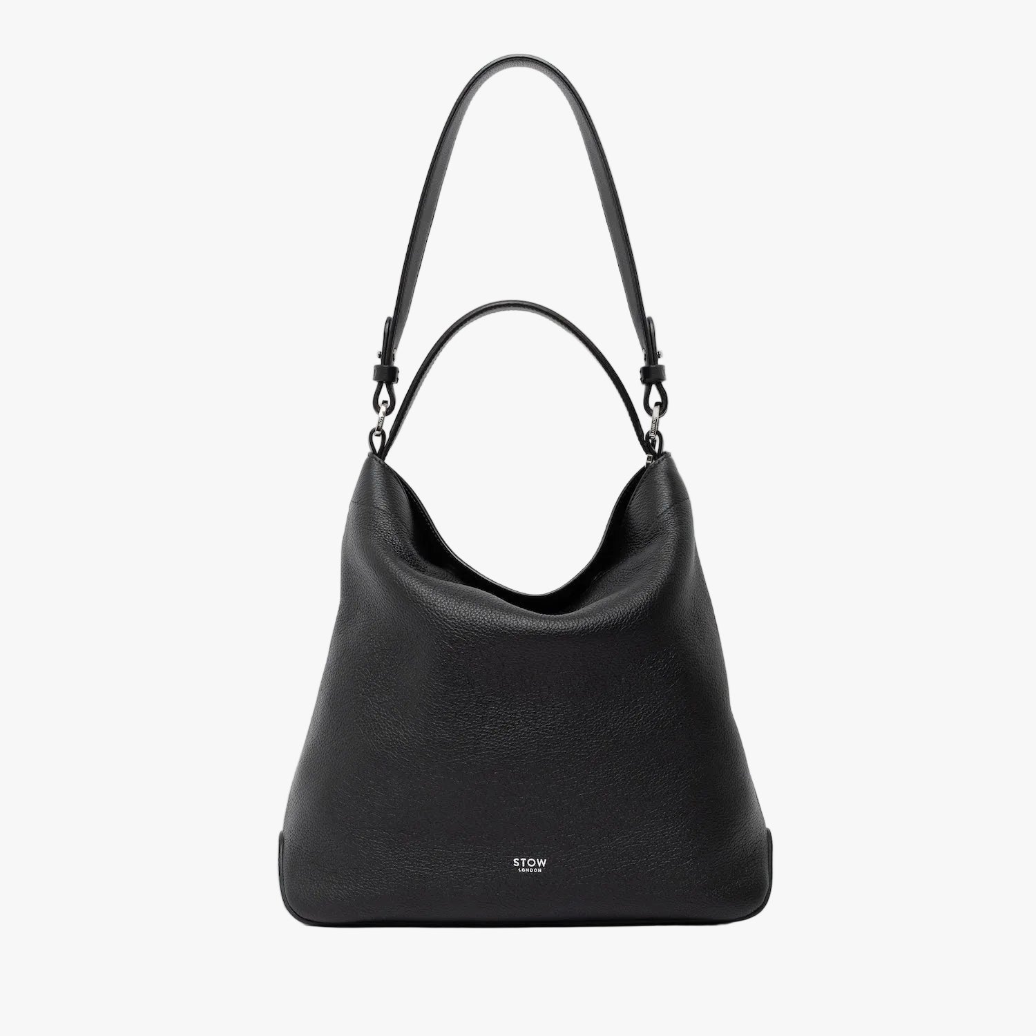STOW London's Curve in Black leather on a light grey background featuring the detachable shoulder strap and its top handle with silver hardware and details