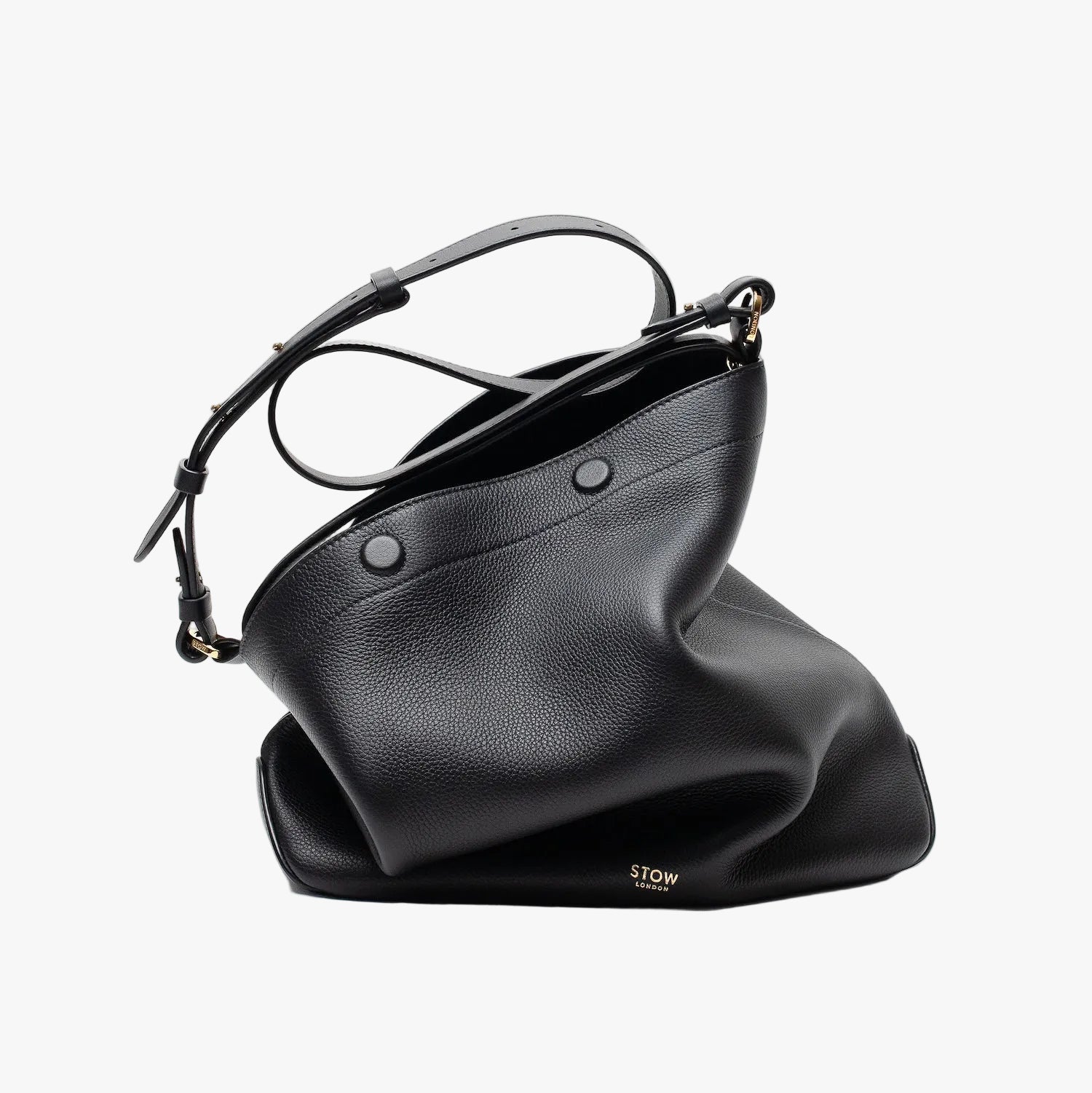 Stow London's Curve bag in Black pebbled leather featuring gold-coated stainless steel hardware on a light grey background