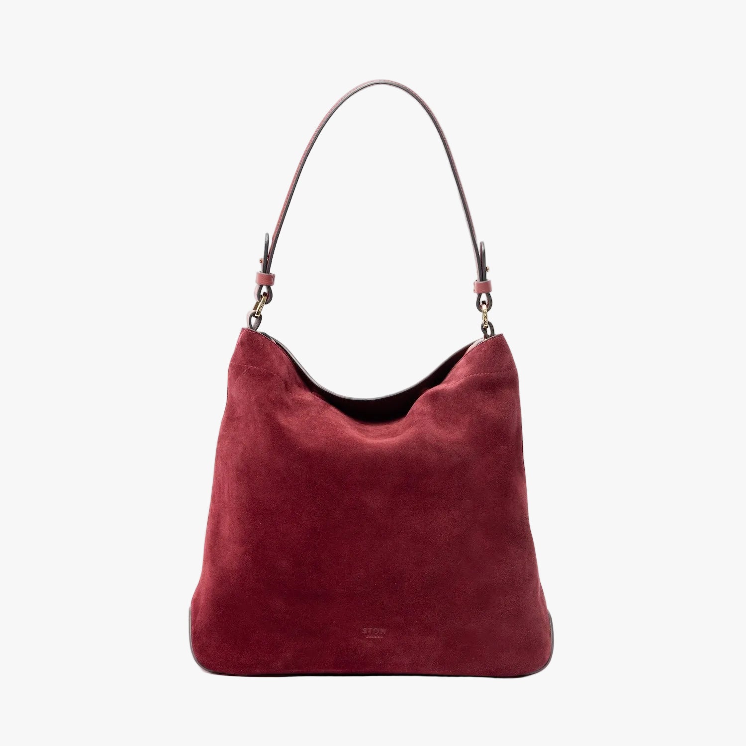 STOW London's Curve in Burgundy suede leather on a light grey background featuring the detachable shoulder strap with gold hardware