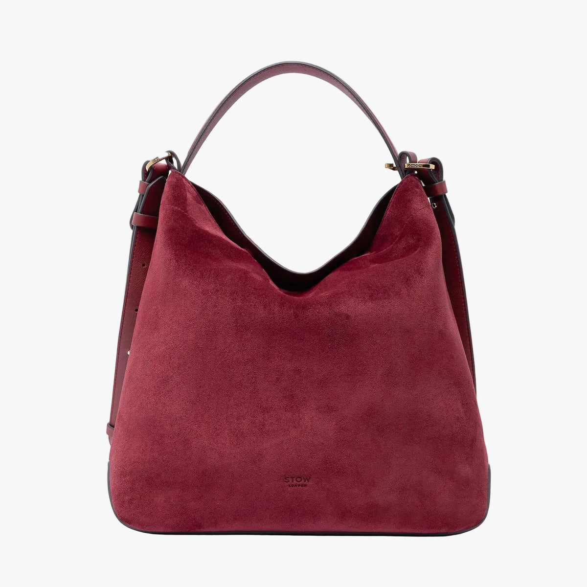 Stow London's Curve bag in Burgundy suede leather featuring gold-coated stainless steel hardware on a light grey background