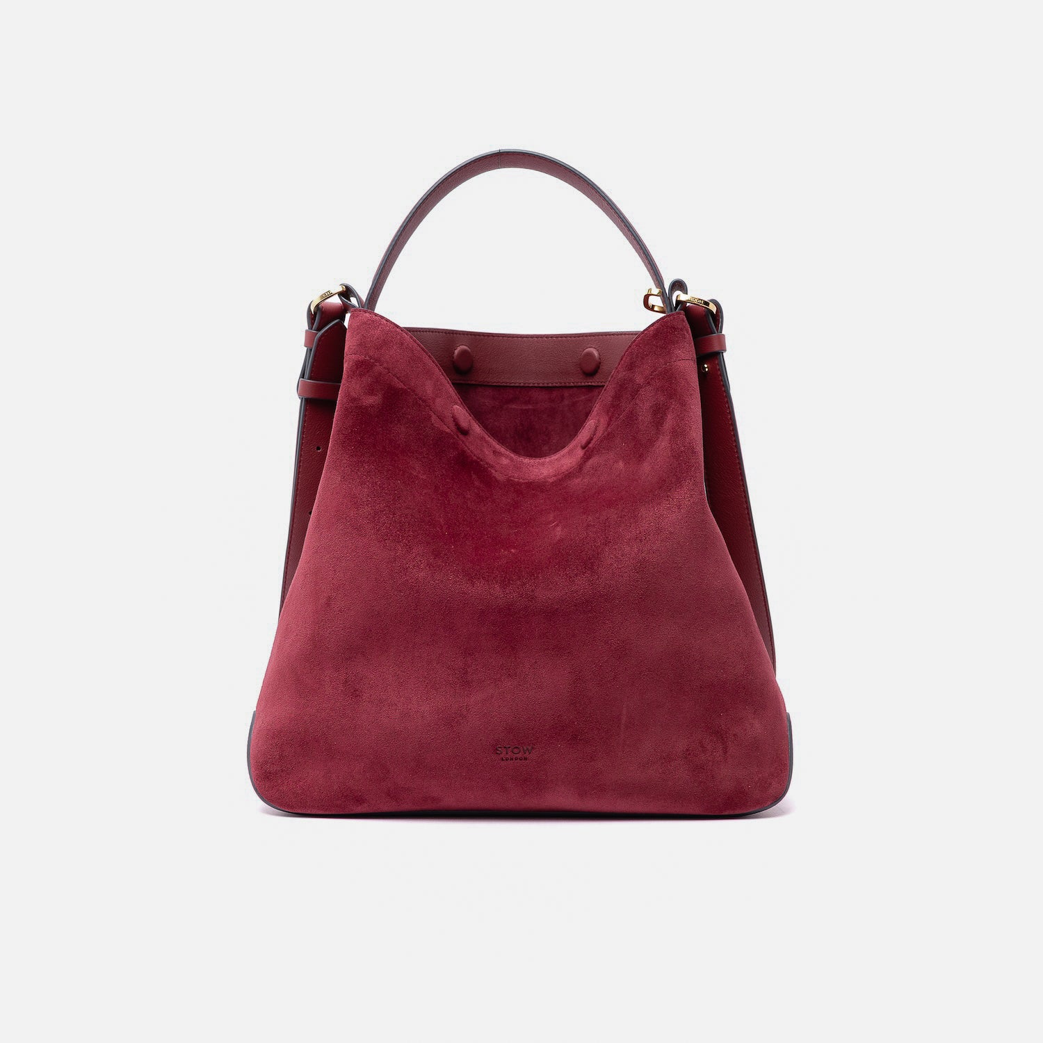 Stow London's Curve bag in Burgundy suede leather with magnets open showing the Burgundy suede interior featuring gold-coated stainless steel hardware on a light grey background