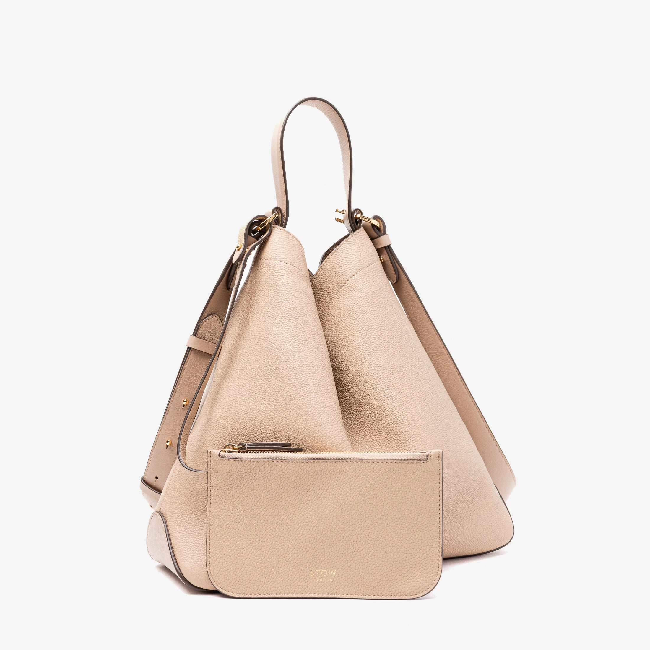 STOW London's Curve bag in Camel pebbled leather featuring its matching detachable interior pouch and gold-coated stainless steel hardware on a light grey background