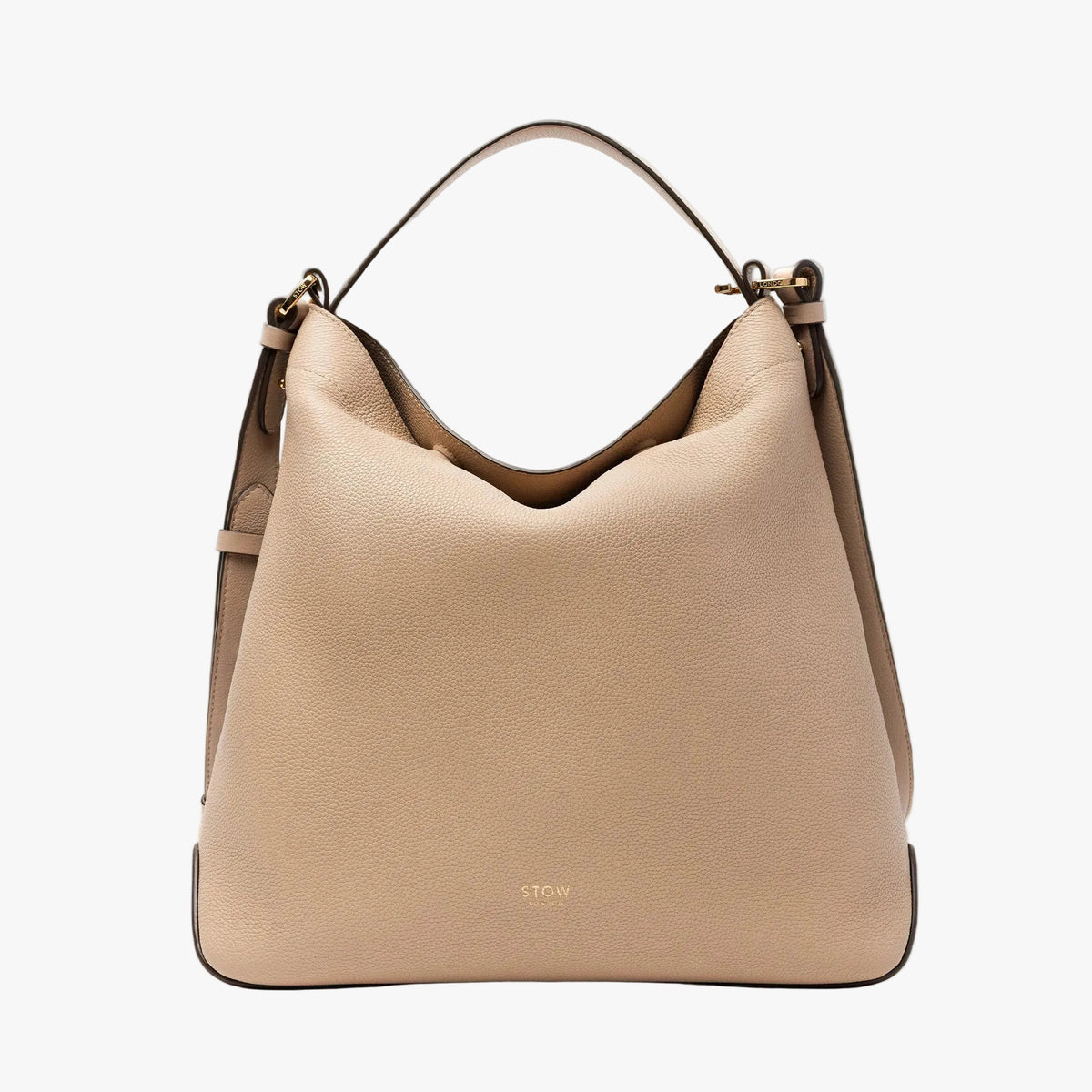 STOW London's Curve bag in Camel pebbled leather featuring gold-coated stainless steel hardware on a light grey background