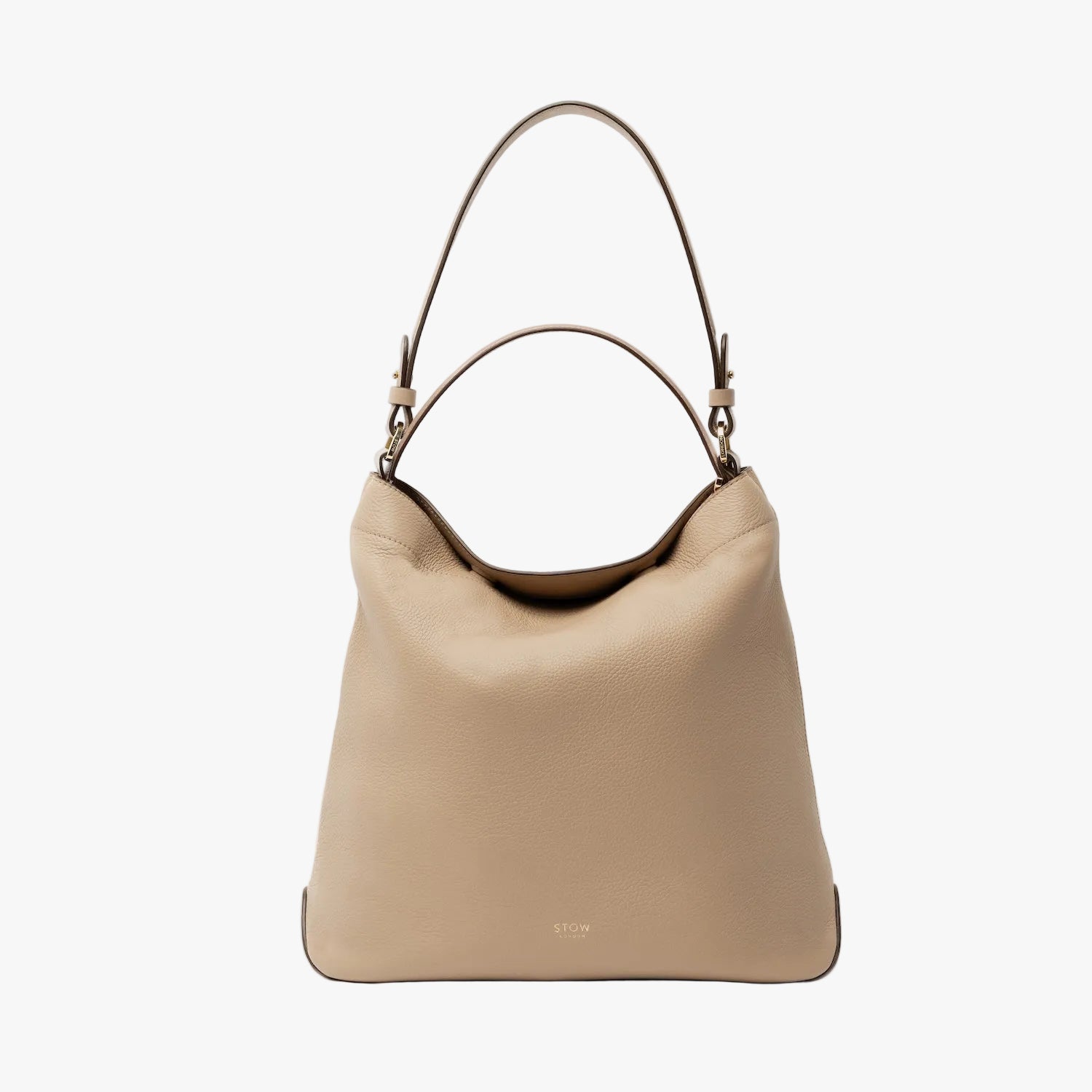 STOW London's Curve in Camel leather on a light grey background featuring the detachable shoulder strap and top handle with gold hardware and details