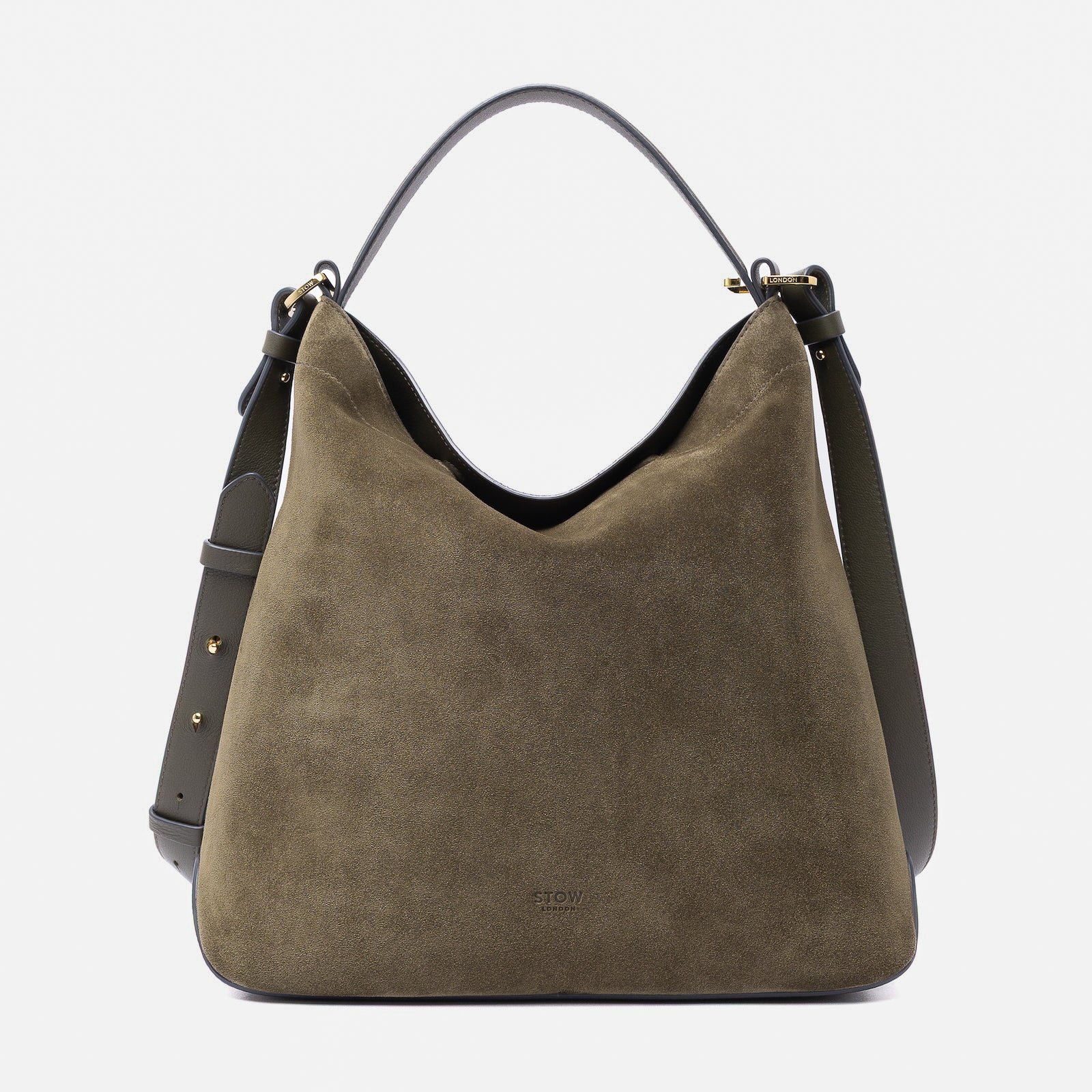 Stow London's Curve bag in Dark Green suede leather featuring gold-coated stainless steel hardware on a light grey background