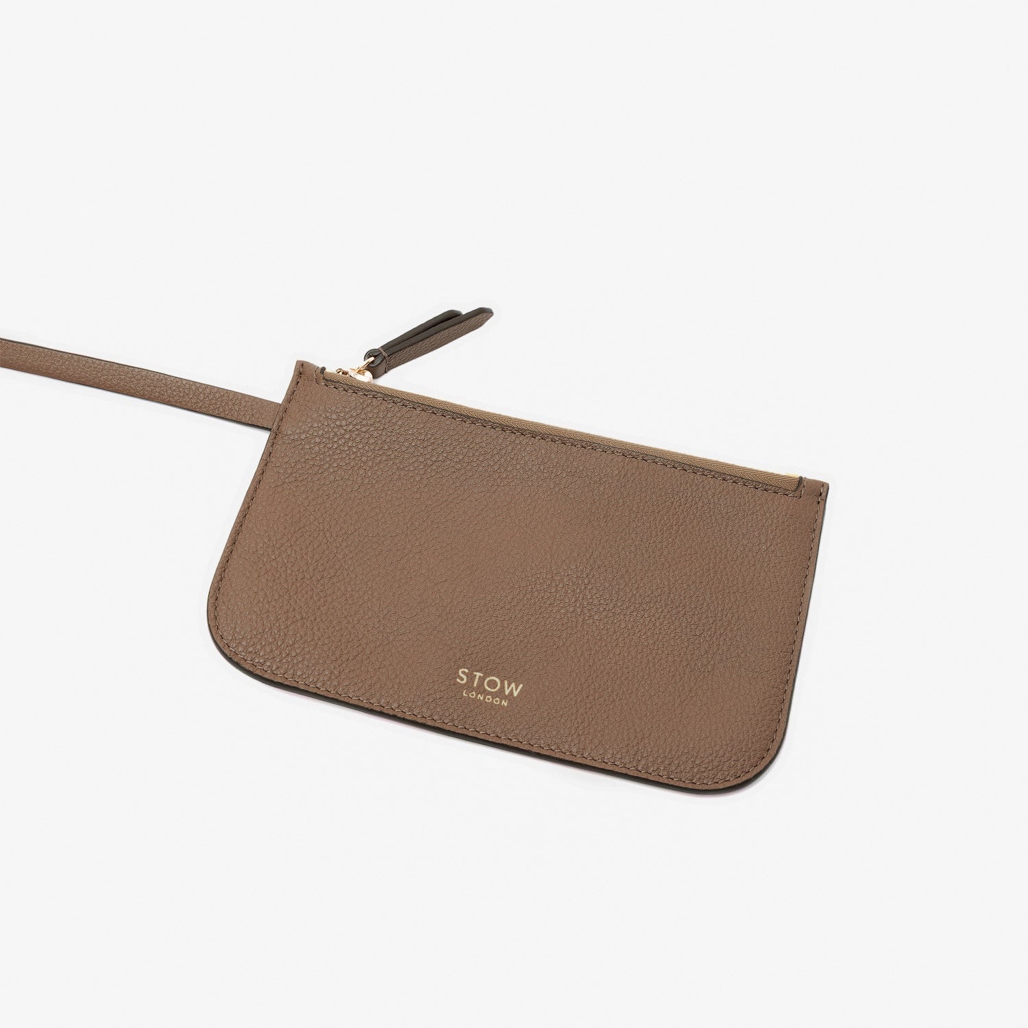 Close up of the detachable interior pouch on STOW London's Curve bag in Mocha pebbled leather on a light grey background