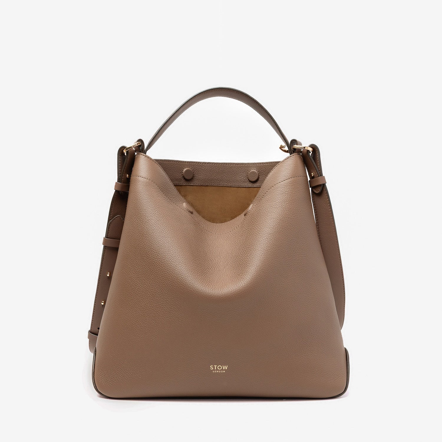STOW London's Curve bag in Mocha pebbled leather with magnets open showing the cognac suede interior featuring gold-coated stainless steel hardware on a light grey background