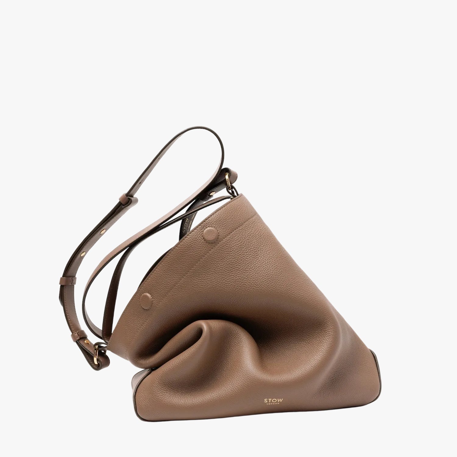 STOW London's Curve bag in Mocha pebbled leather featuring gold-coated stainless steel hardware on a light grey background