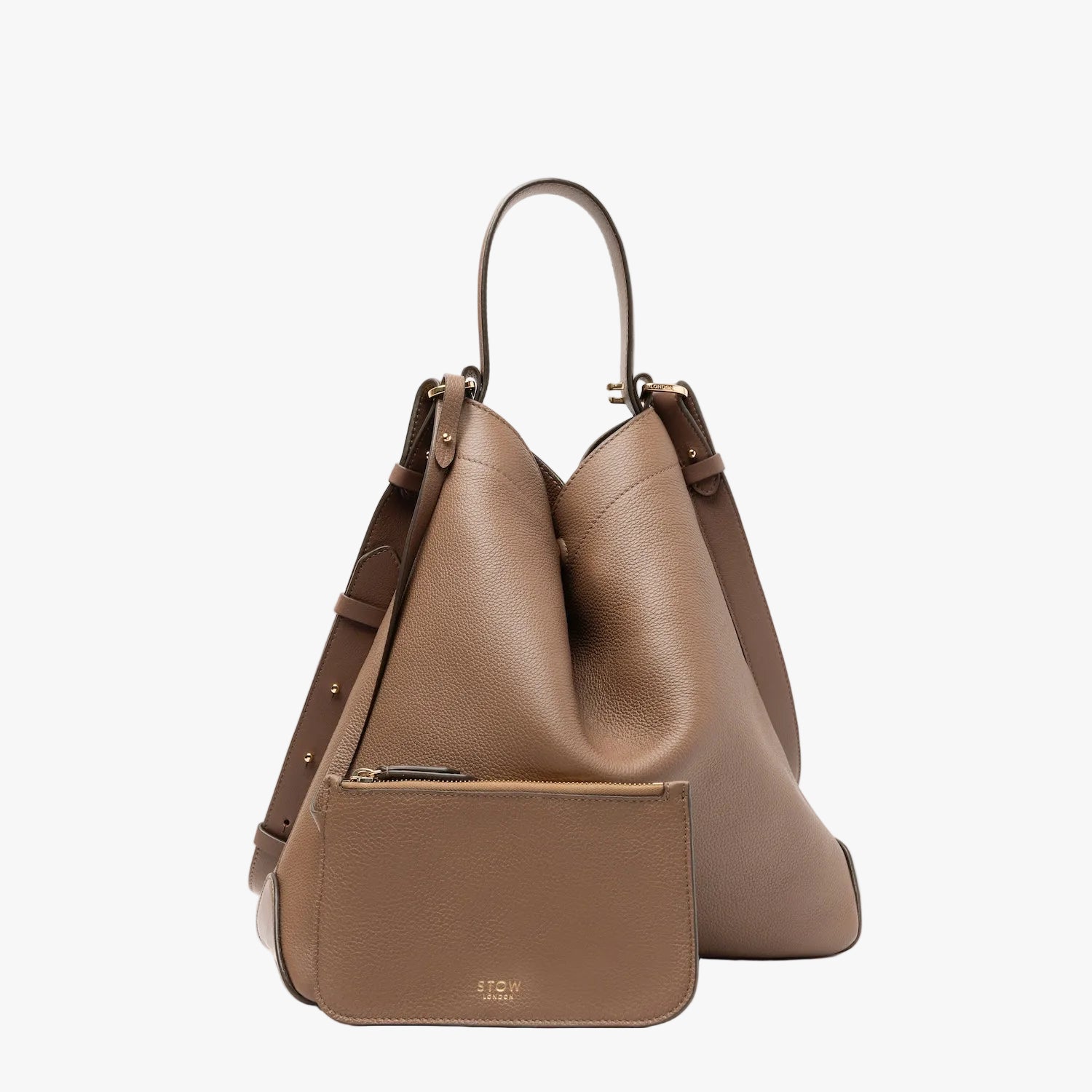 STOW London's Curve bag in Mocha pebbled leather shaped in its triangular form with its matching interior zip pouch featuring gold-coated stainless steel hardware on a light grey background