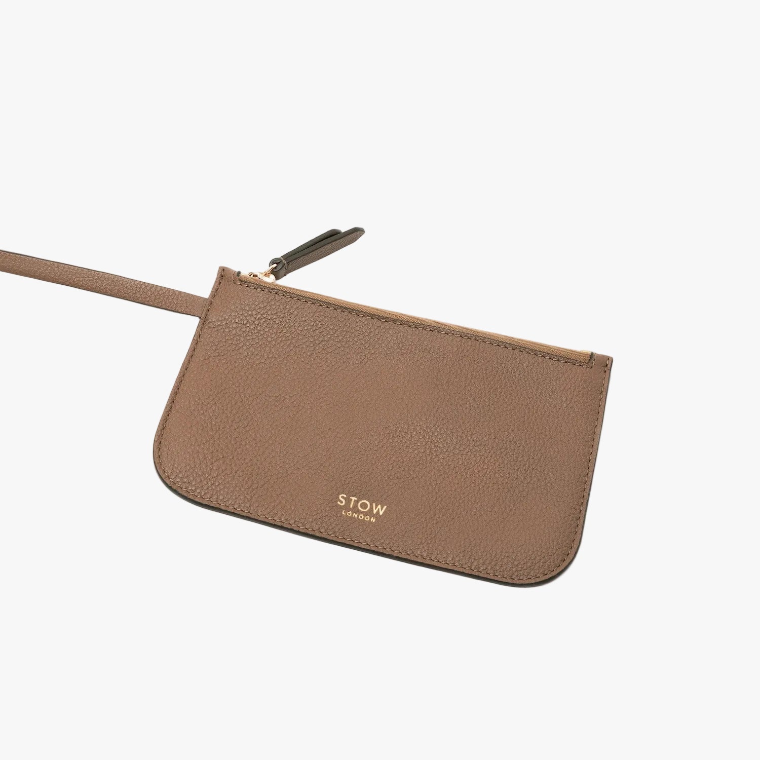 Close up of the detachable zip pouch from STOW London's Curve bag in Mocha pebbled leather featuring gold-coated stainless steel hardware on a light grey background