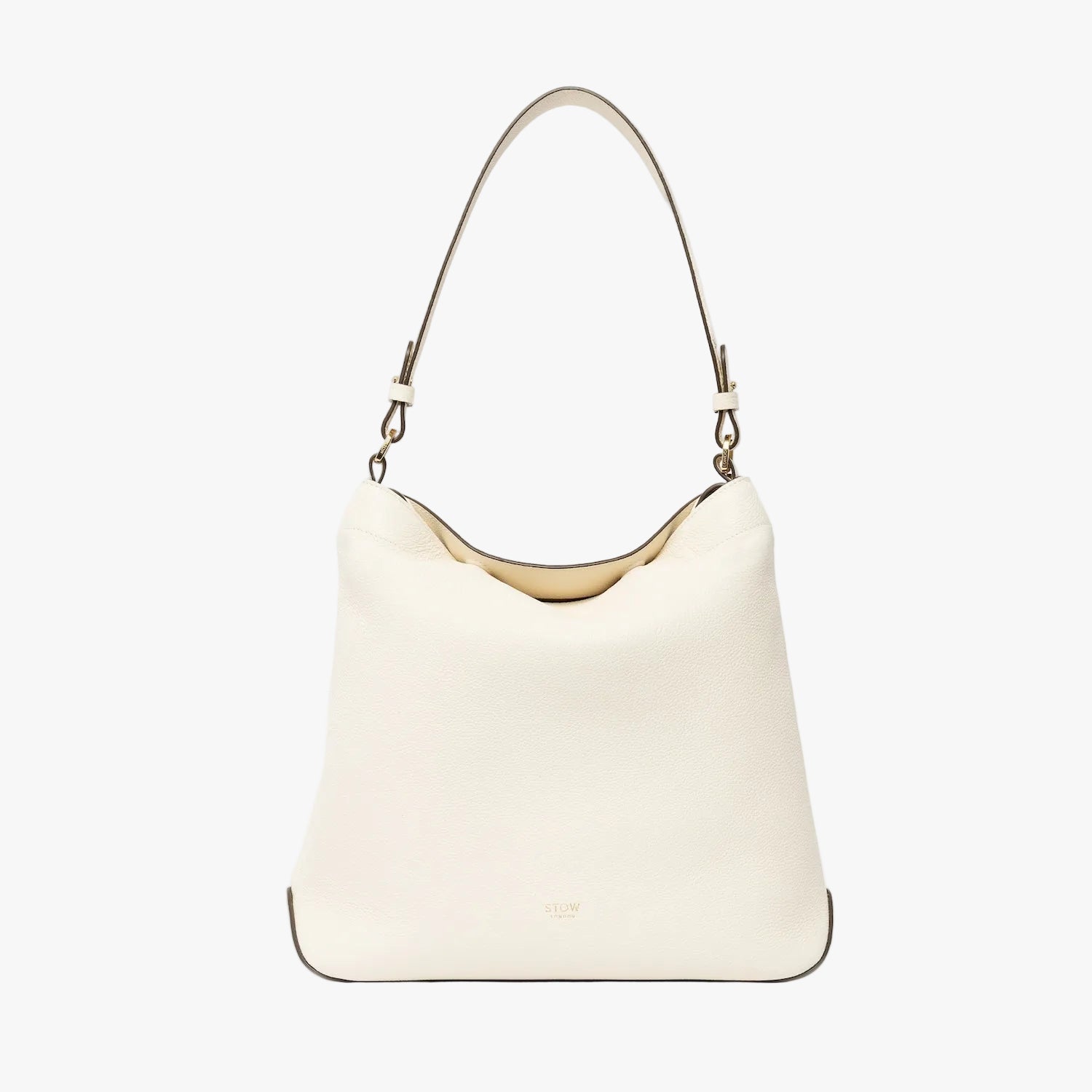 STOW London's Curve in Spring Moon leather on a light grey background featuring the detachable shoulder strap with gold hardware and details