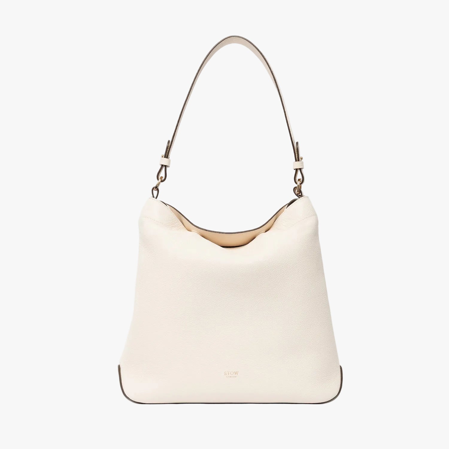 STOW London's Curve in Spring Moon leather on a light grey background featuring the detachable shoulder strap with gold hardware and details