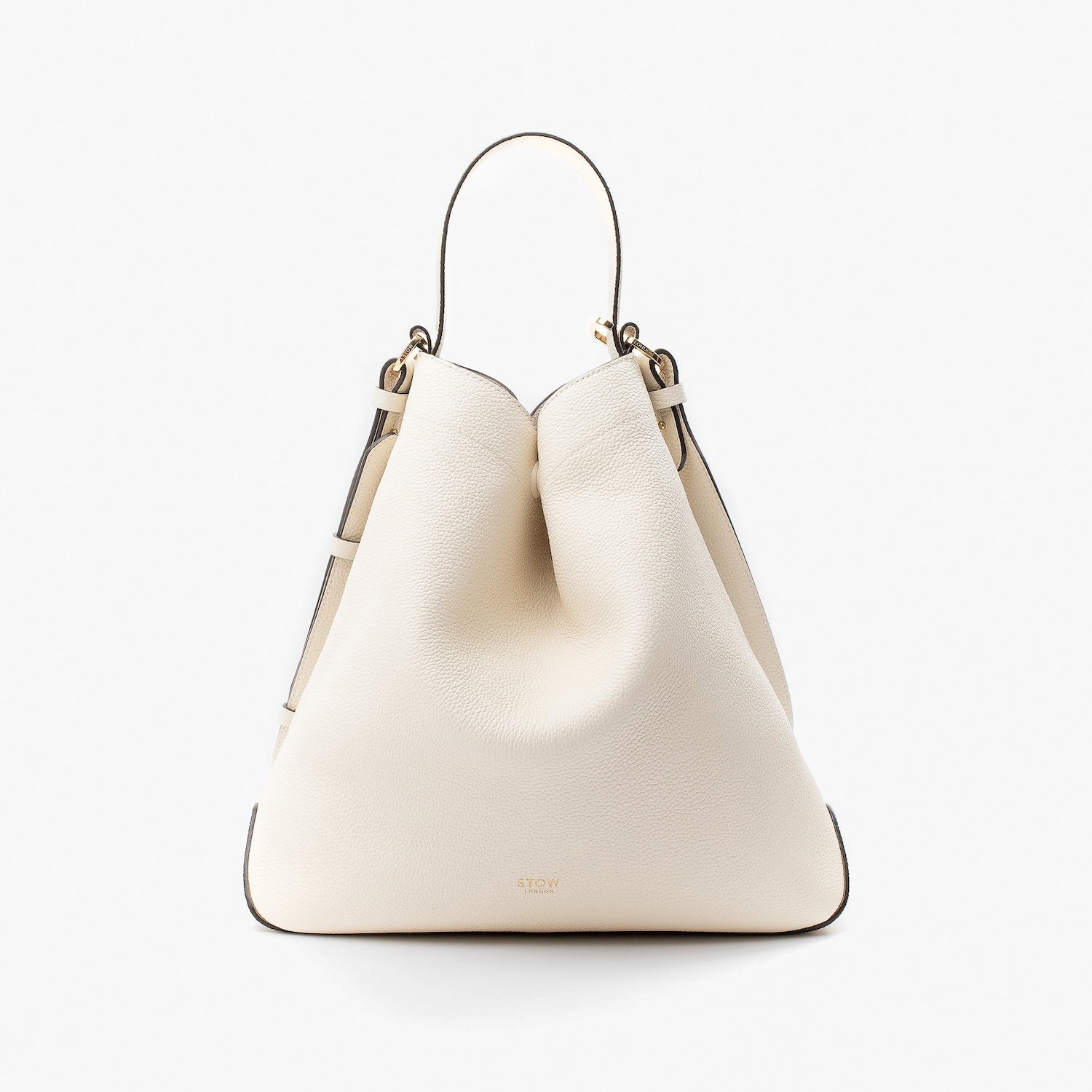 Stow London's Curve bag in Spring Moon pebbled leather in a triangular shape featuring gold-coated stainless steel hardware on a light grey background