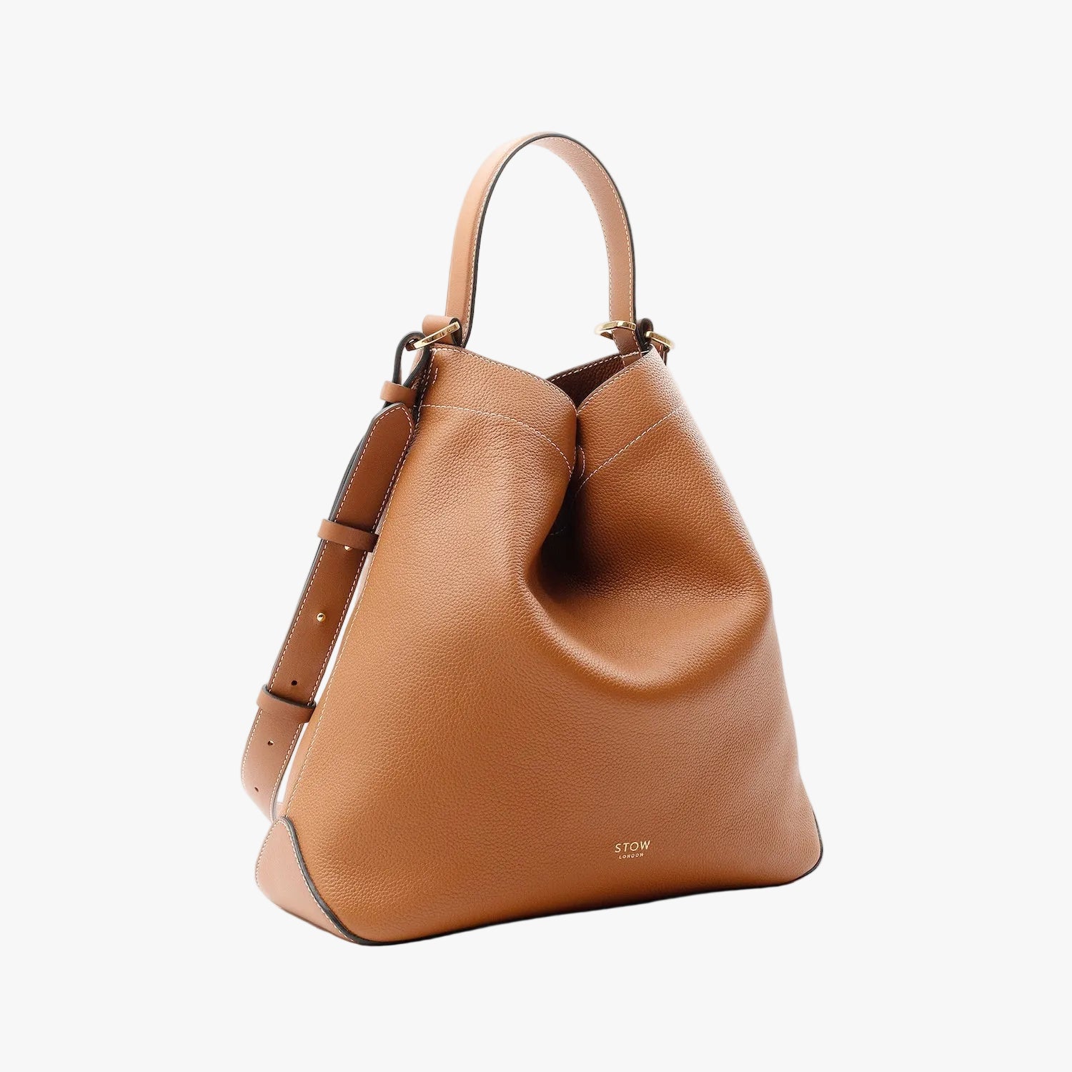 Off-axis view of STOW London's Curve in Earth tan pebbled leather on a light grey background