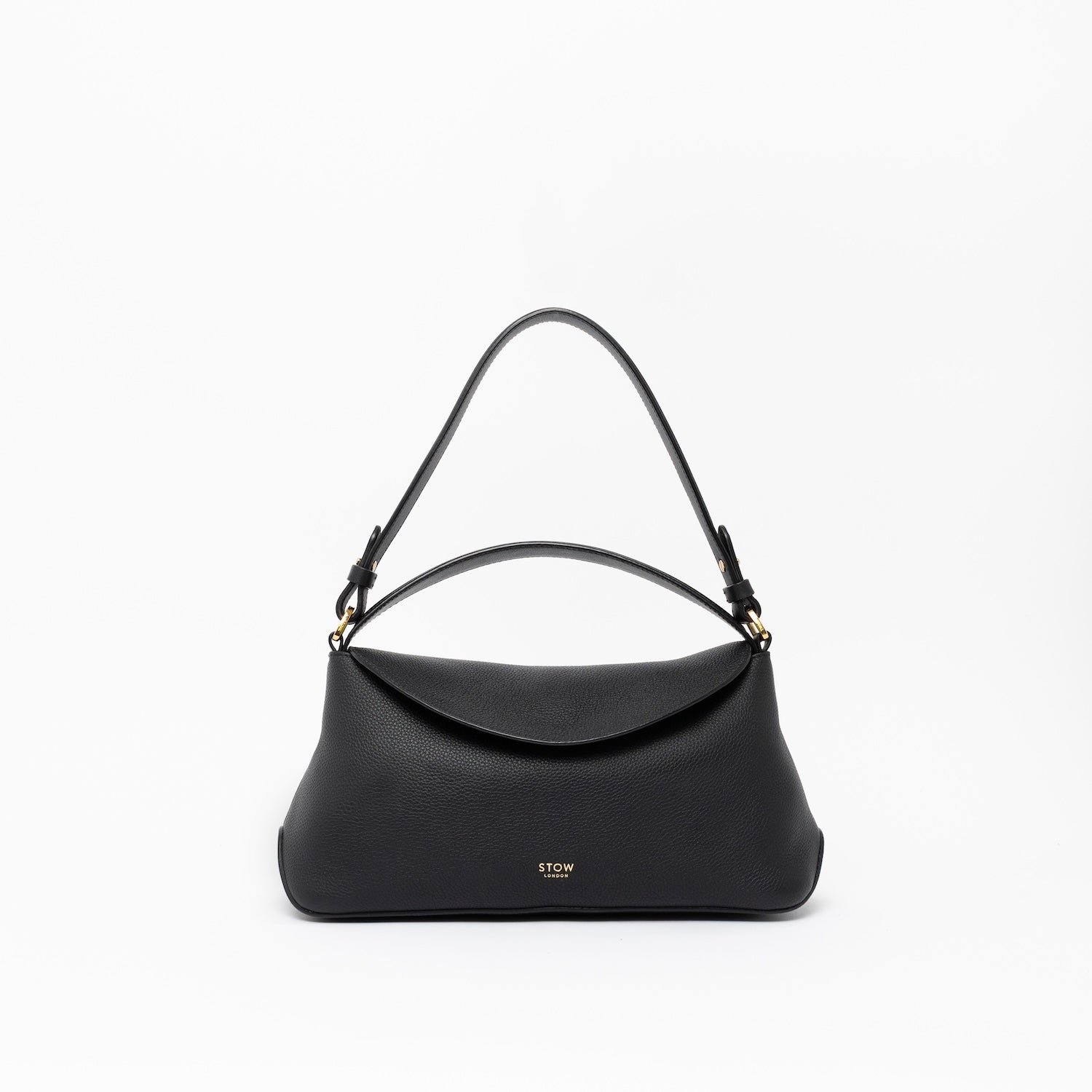 STOW London's East West in Black leather on a light grey background featuring the detachable shoulder strap and top handle with gold hardware and details