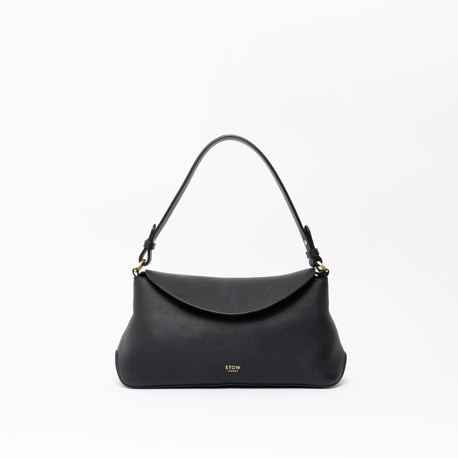 STOW London's East West in Black leather on a light grey background featuring the detachable shoulder strap with gold hardware and details