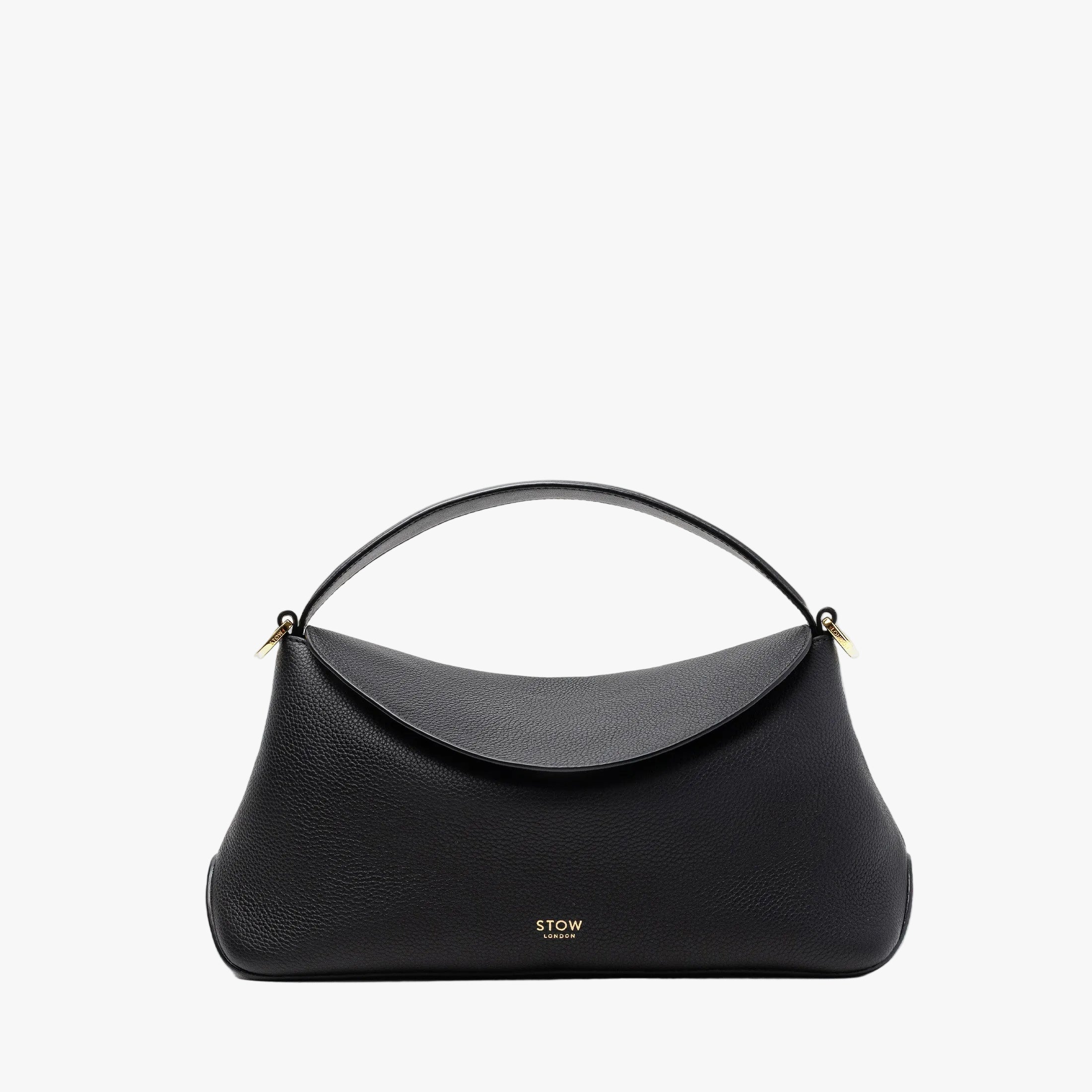 STOW London's East West in Black pebbled leather featuring gold-coated stainless steel hardware on a light grey background