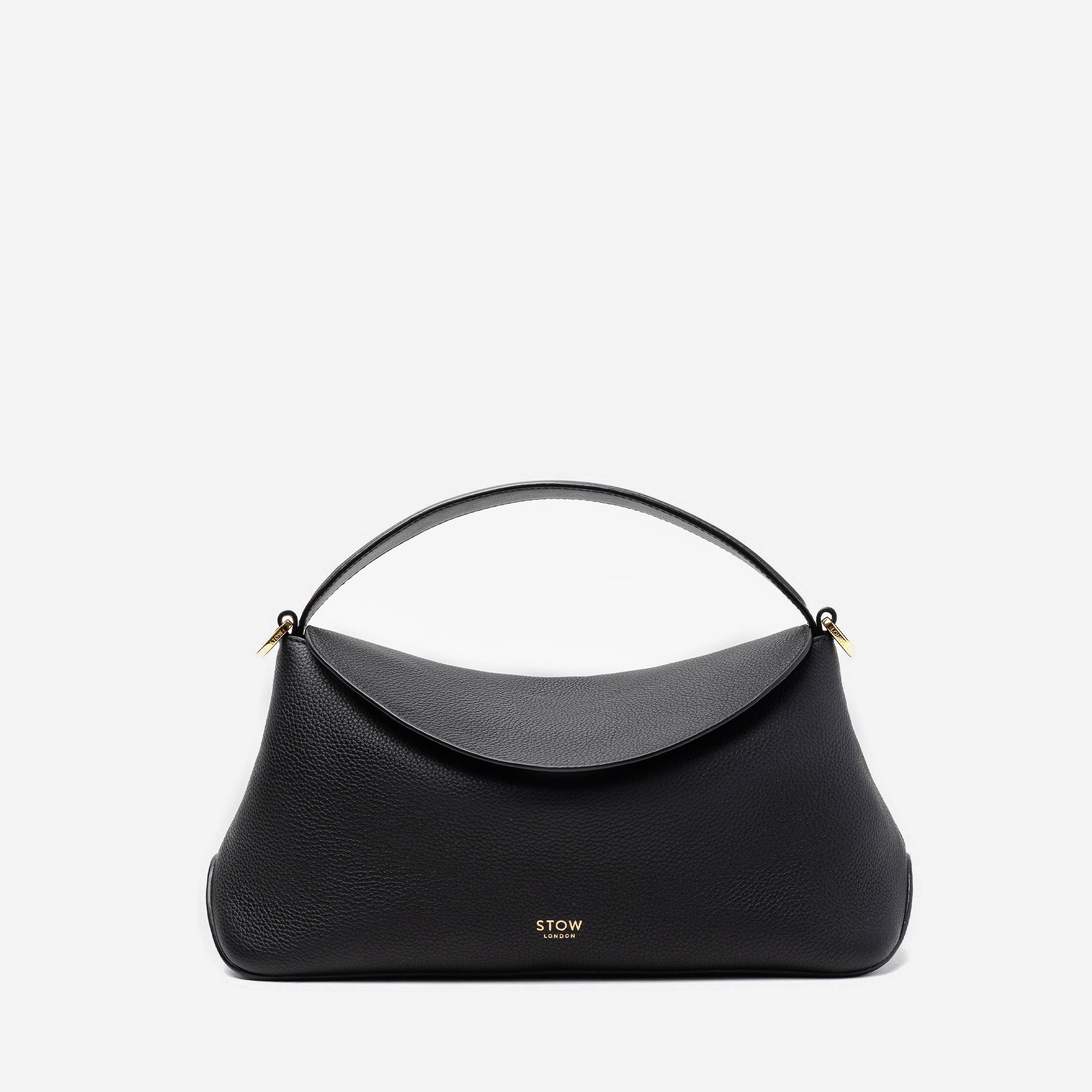 STOW London's East West in Black pebbled leather featuring gold-coated stainless steel hardware on a light grey background