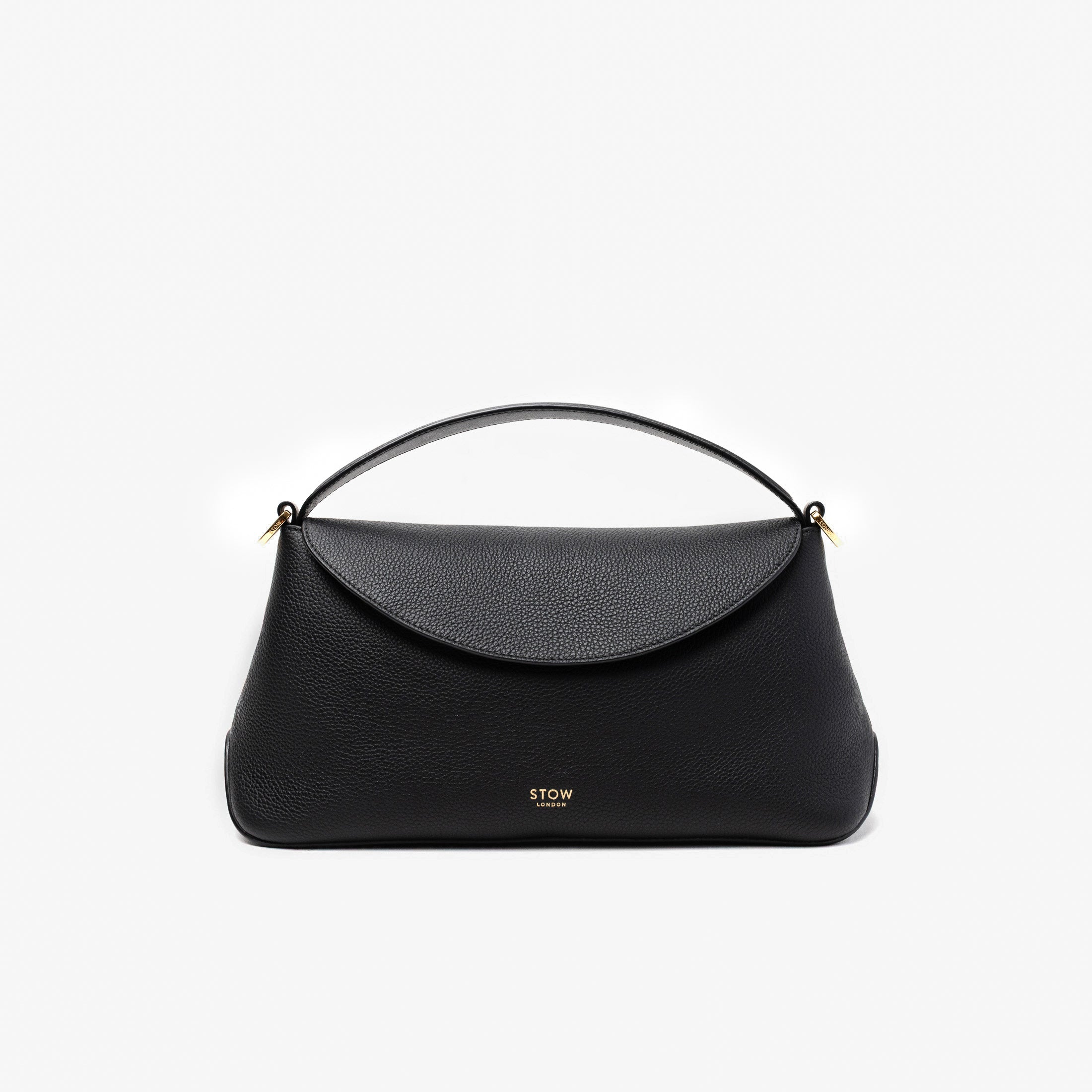 STOW London's East West in Black pebbled leather featuring gold-coated stainless steel hardware on a light grey background
