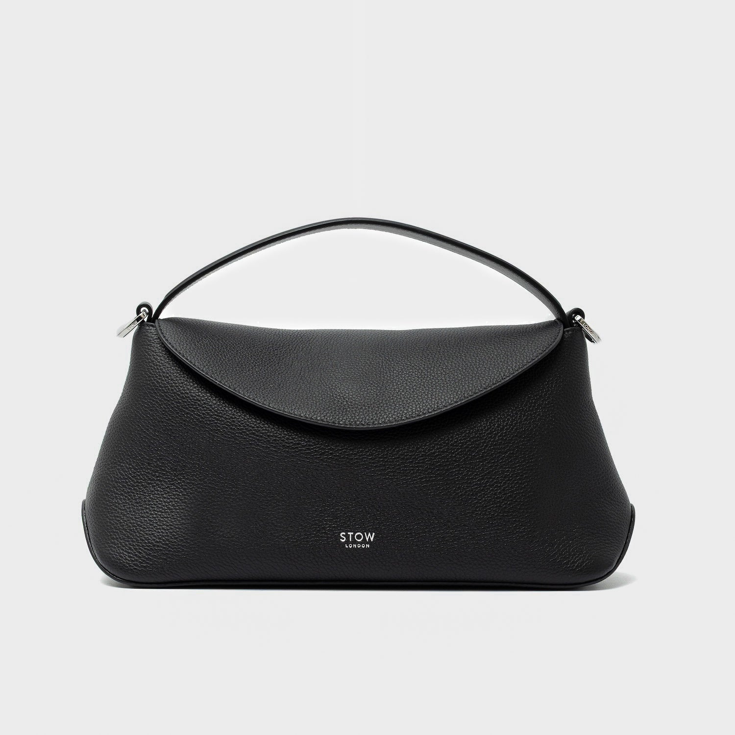 STOW London's East West in Black pebbled leather featuring silver stainless steel hardware on a light grey background