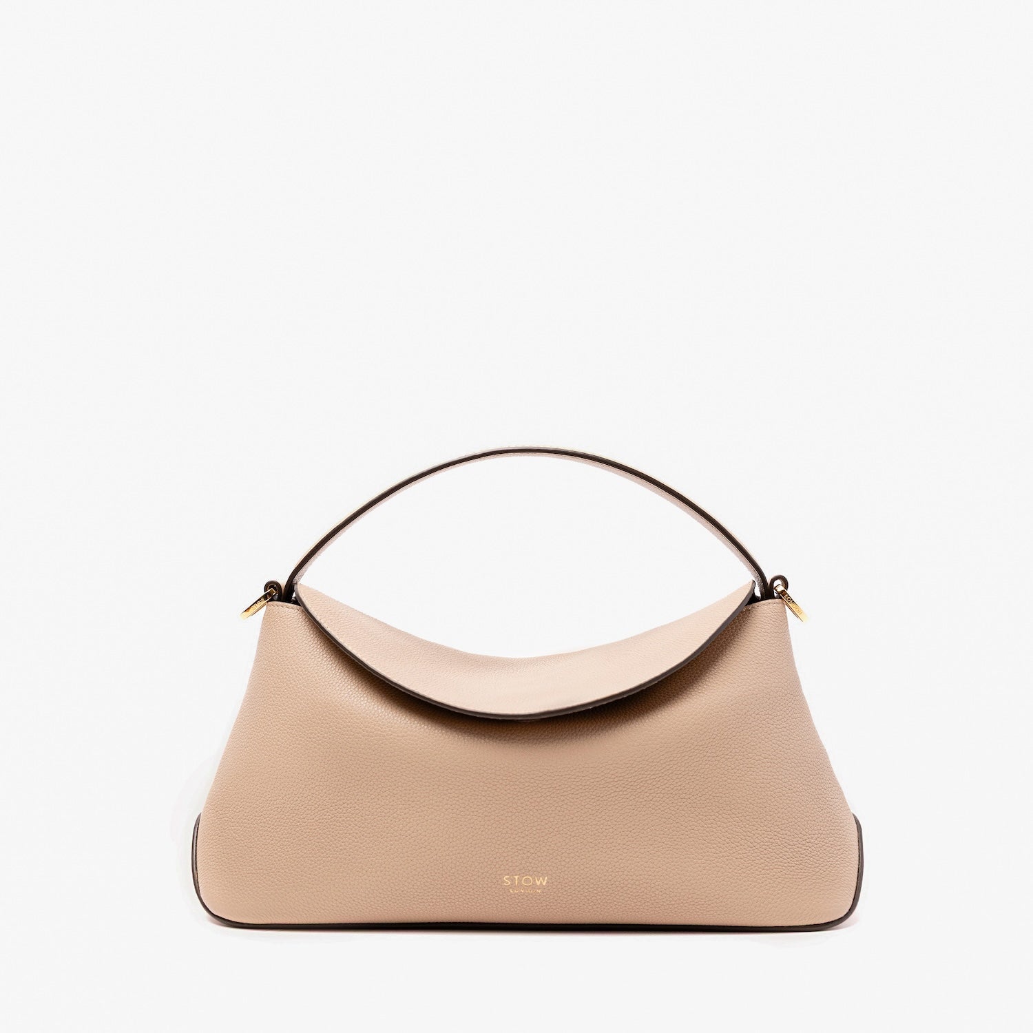 STOW London's East West in Camel pebbled leather featuring gold-coated stainless steel hardware on a light grey background