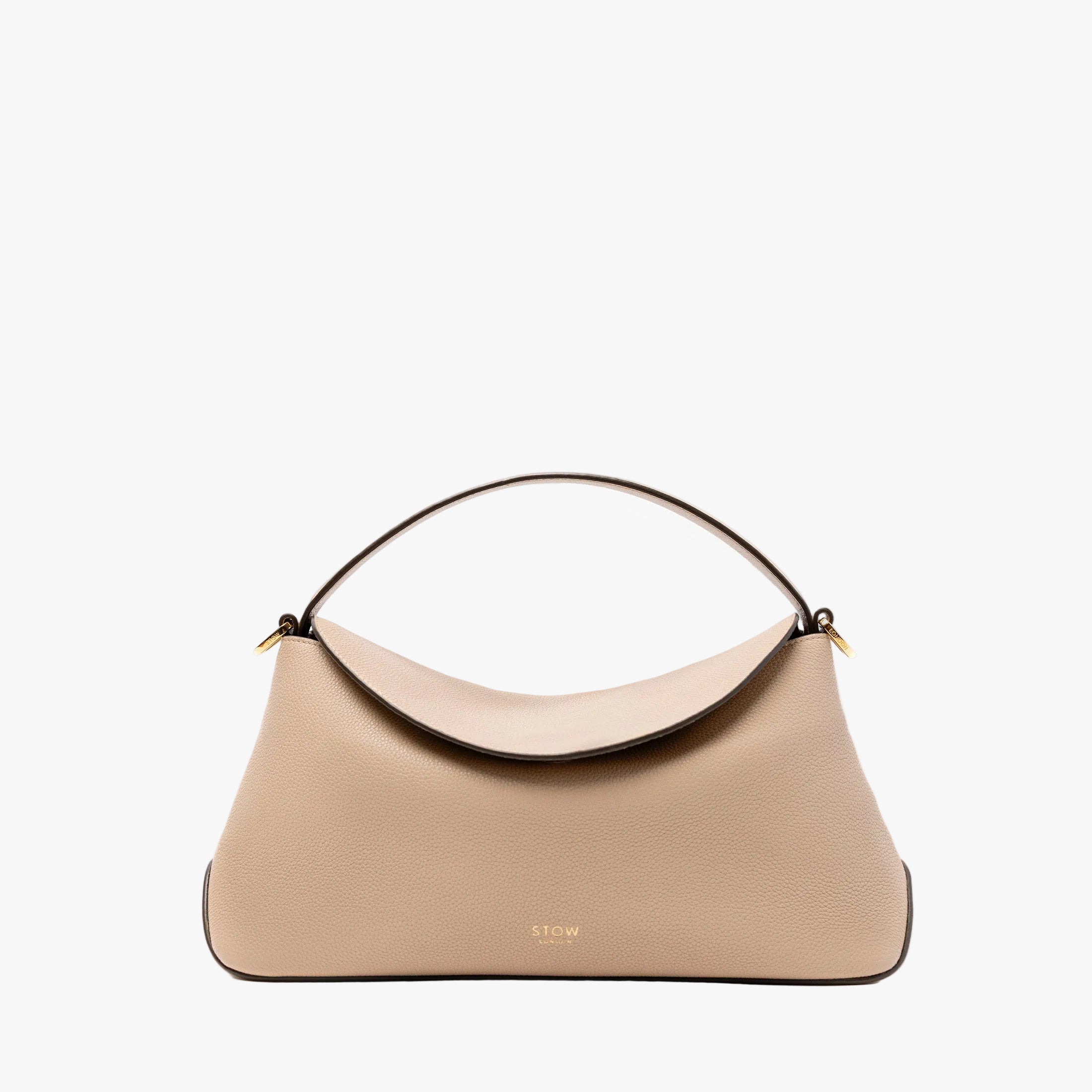 STOW London's East West in Camel pebbled leather featuring gold-coated stainless steel hardware on a light grey background