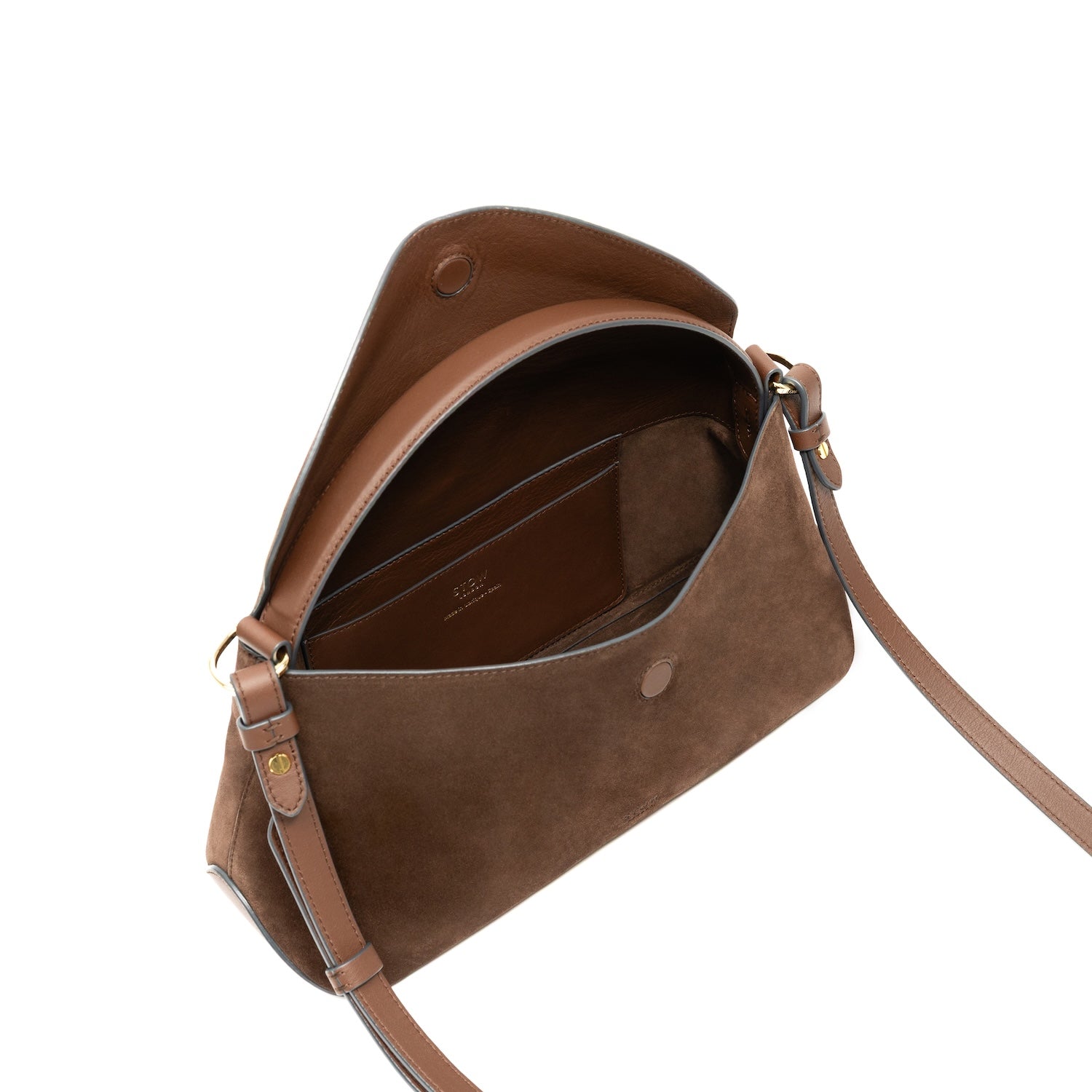 Top angled view of STOW London's East West bag in Chocolate Suede leather with flap open showing interior card pocket featuring gold-coated stainless steel hardware on a white background