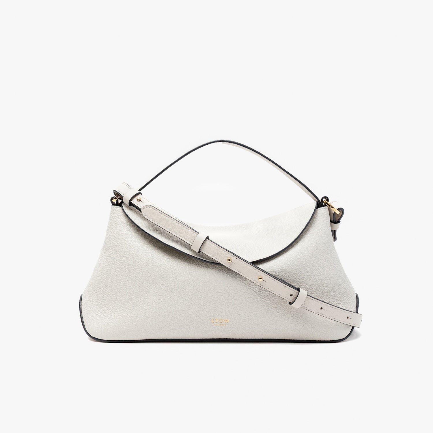 STOW London's East West in Cloud Grey pebbled leather and detachable crossbody strap featuring gold-coated stainless steel hardware on a light grey background
