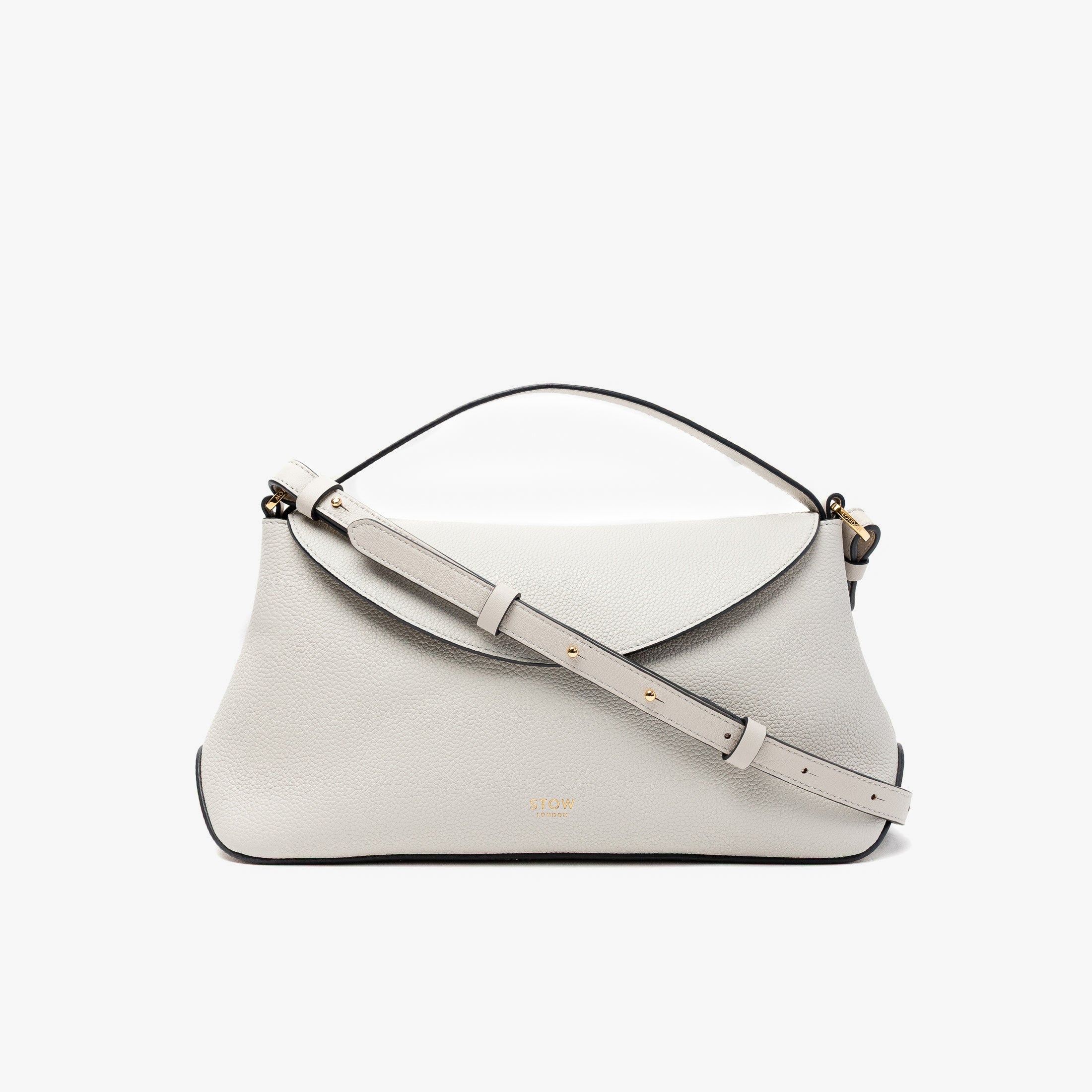 STOW London's East West in Cloud Grey pebbled leather and detachable crossbody strap featuring gold-coated stainless steel hardware on a light grey background