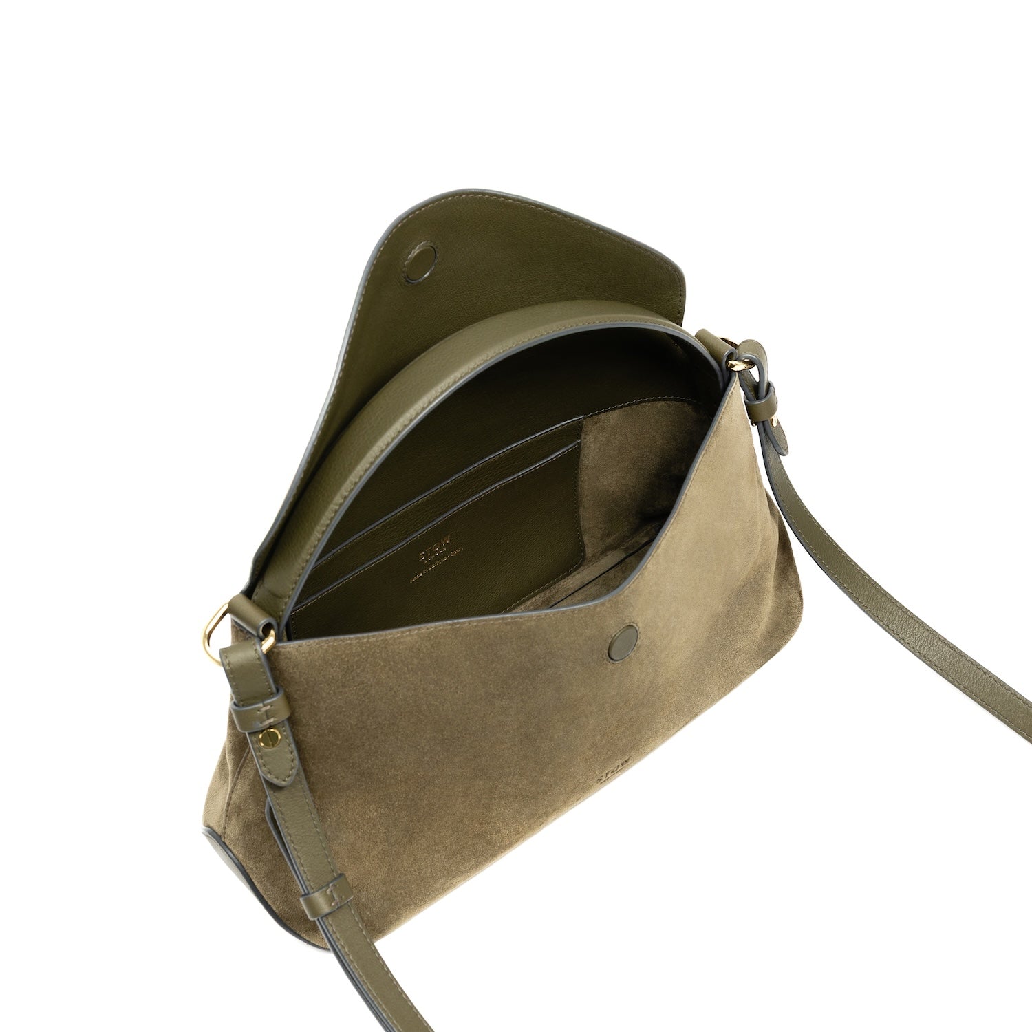 Top angled view of STOW London's East West bag in Dark Green Suede leather with flap open showing interior card pocket featuring gold-coated stainless steel hardware on a white background