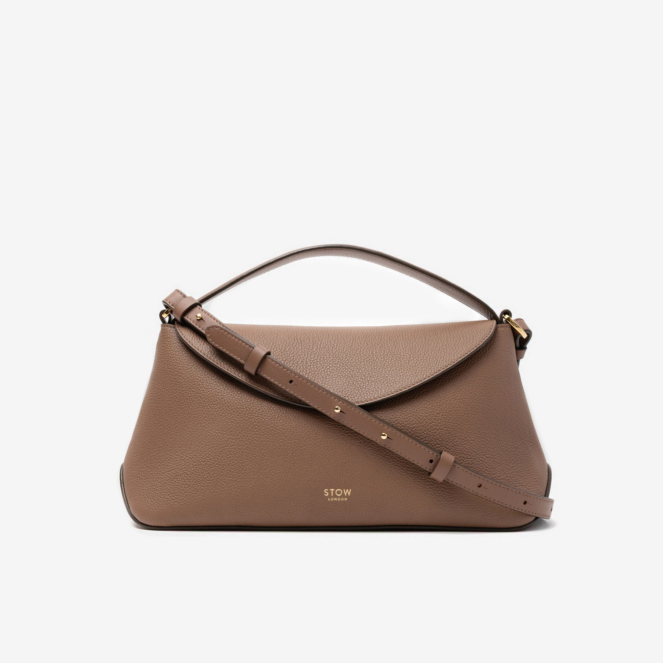 STOW London's East West in Mocha pebbled leather and detachable crossbody strap featuring gold-coated stainless steel hardware on a light grey background