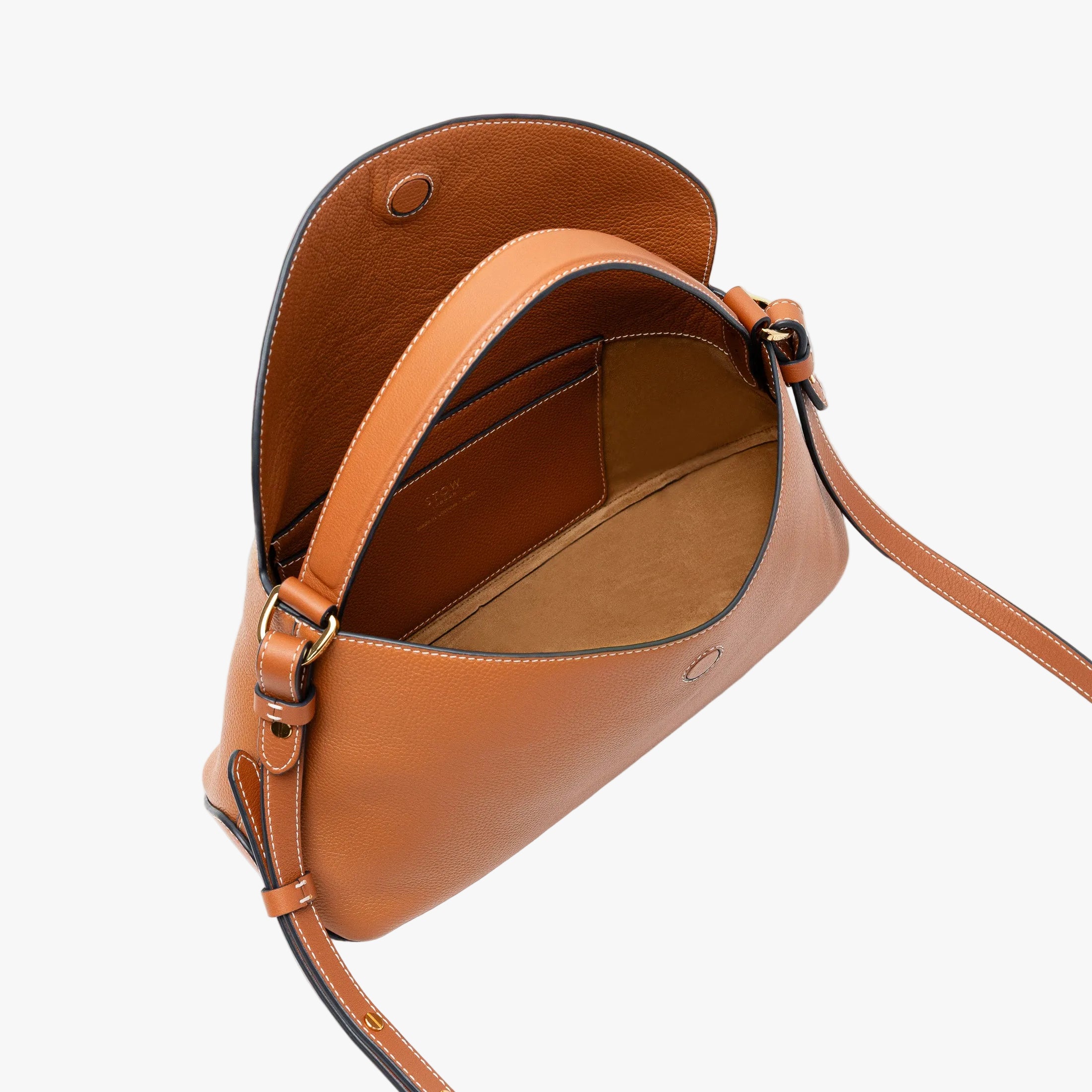 STOW London's East West bag in Earth Tan pebbled leather with flap open showing light beige suede interior and slip pocket featuring gold-coated stainless steel hardware on a light grey background