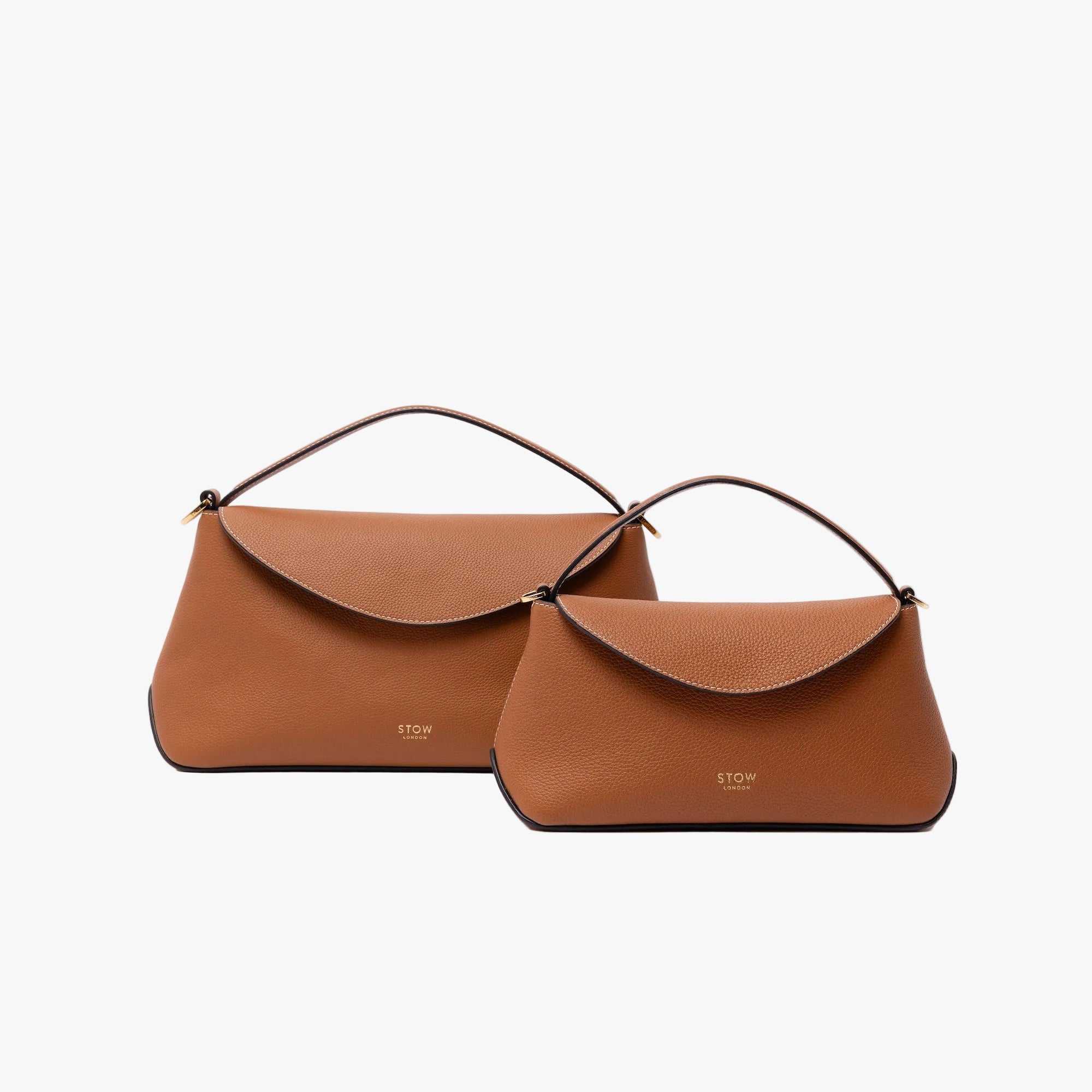 Size comparison of STOW London's Mini East West bag in Earth Tan pebbled and smooth leather to the bigger East West bag in Earth Tan on a white background