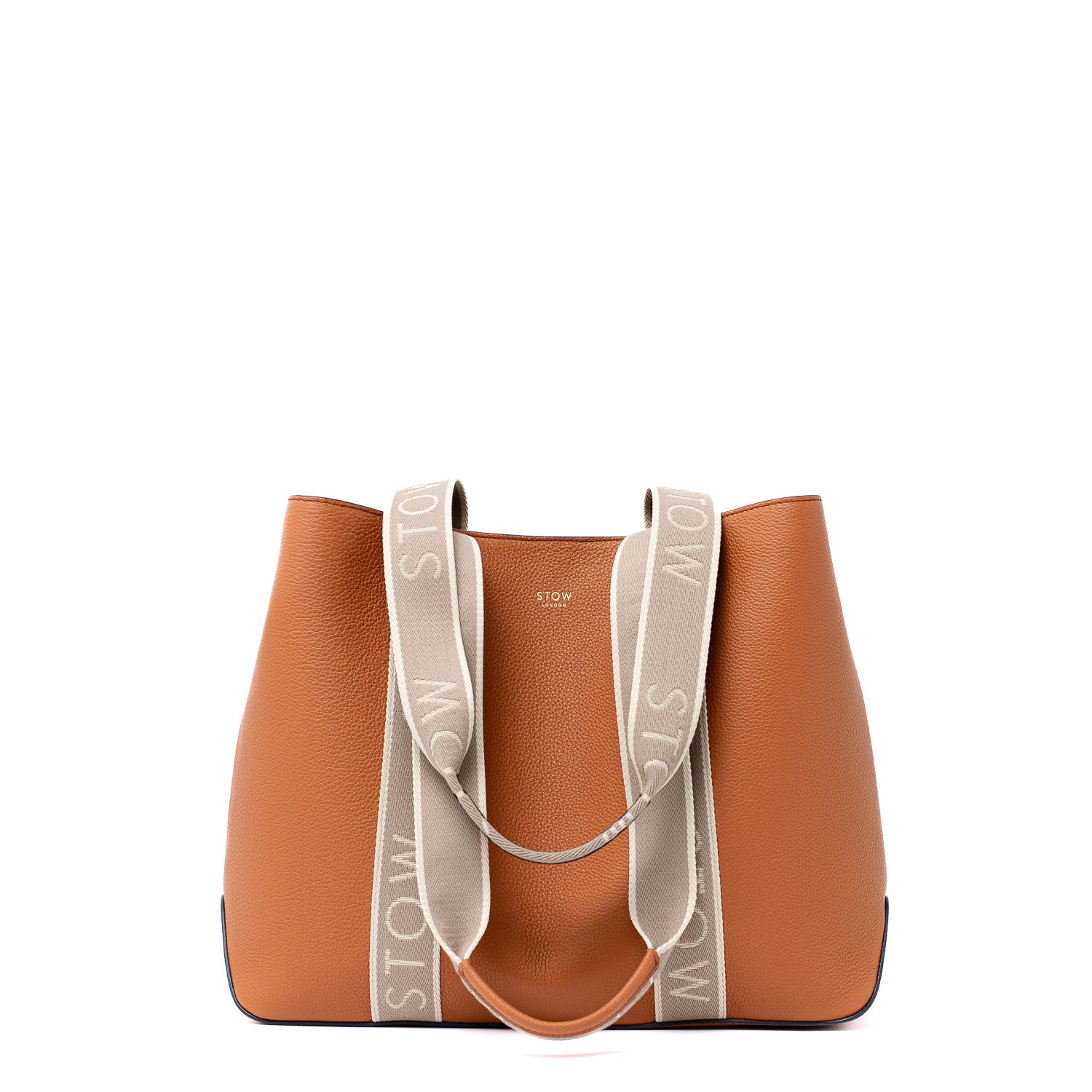 Front view of STOW London's Nastro Tote bag in Earth Tan pebbled leather with STOW branded handles down on a white background